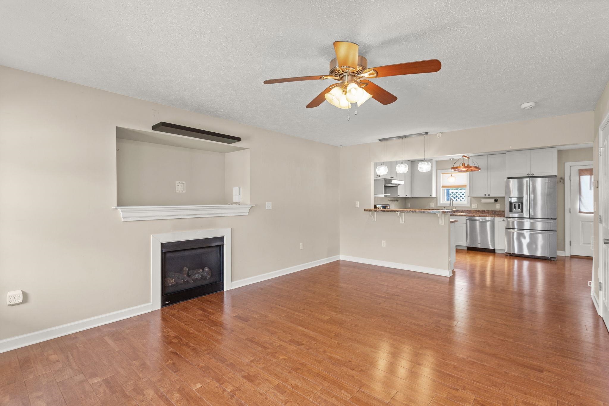 with gas fireplace and open to kitchen with breakfast bar with gas fireplace and open to kitchen with breakfast bar