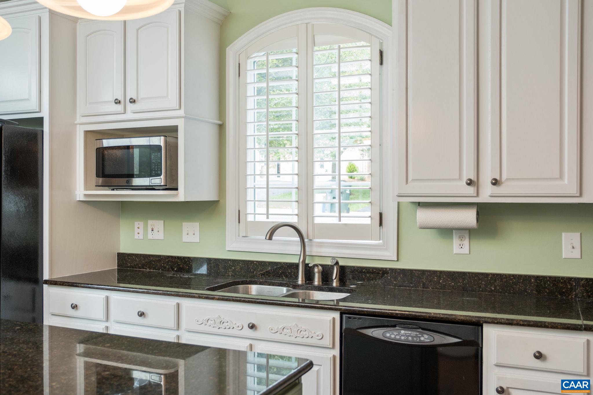 The home features custom blinds throughout, including over the kitchen window. The home features custom blinds throughout, including over the kitchen window.