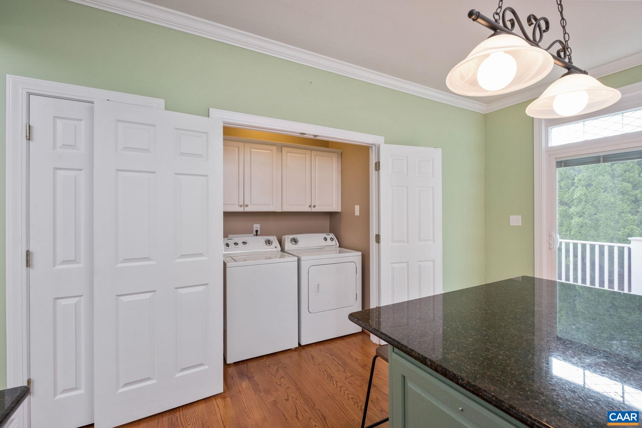 The laundry area features cabinetry. The laundry area features cabinetry.