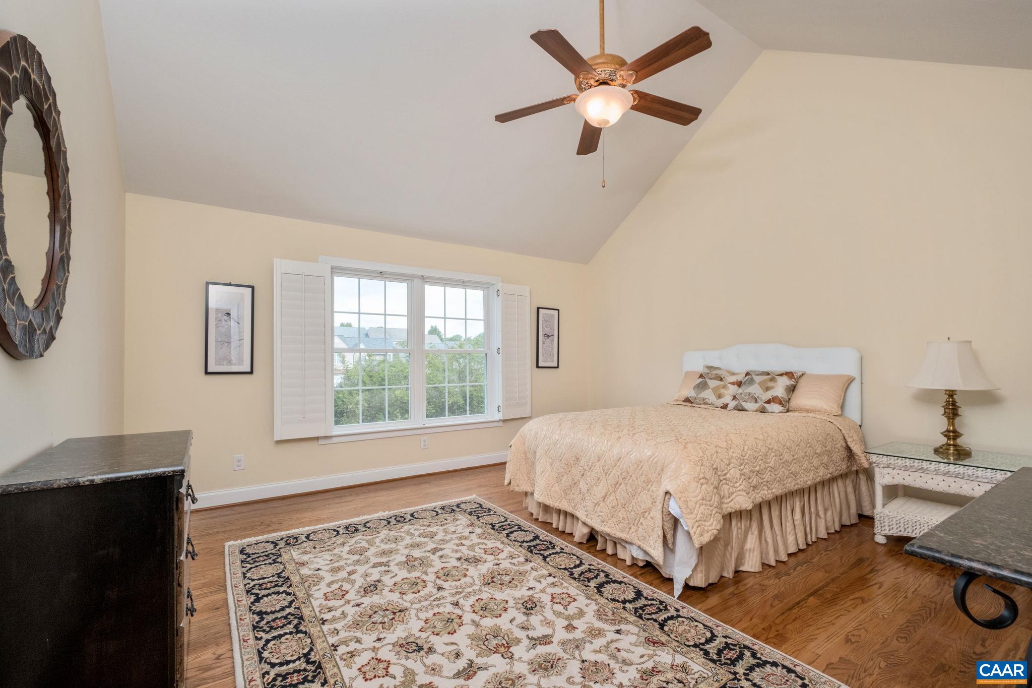 This second level bedroom is at the top of the stairs and features a vaulted ceiling, walk-in closet, and custom blinds. This second level bedroom is at the top of the stairs and features a vaulted ceiling, walk-in closet, and custom blinds.