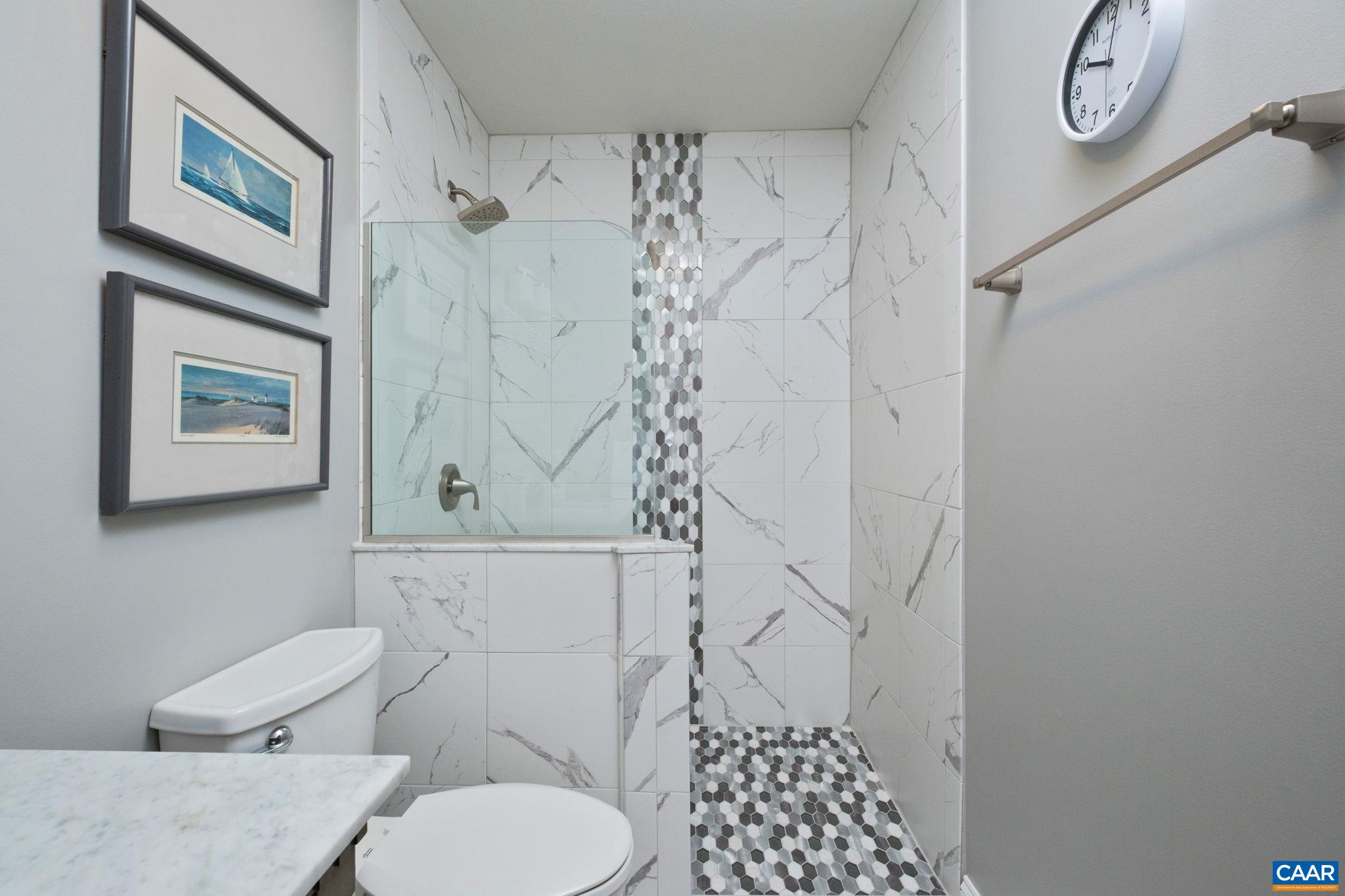 Tiled shower is in view. Tiled shower is in view.