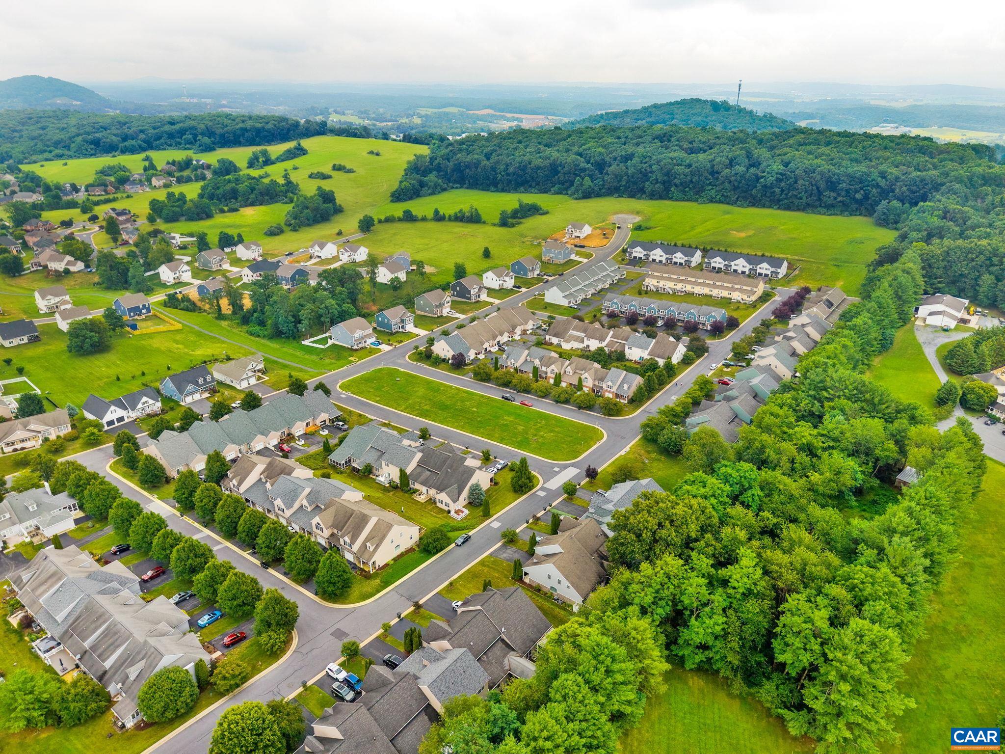The view from the drone captures the greenspace in front of the property. The view from the drone captures the greenspace in front of the property.