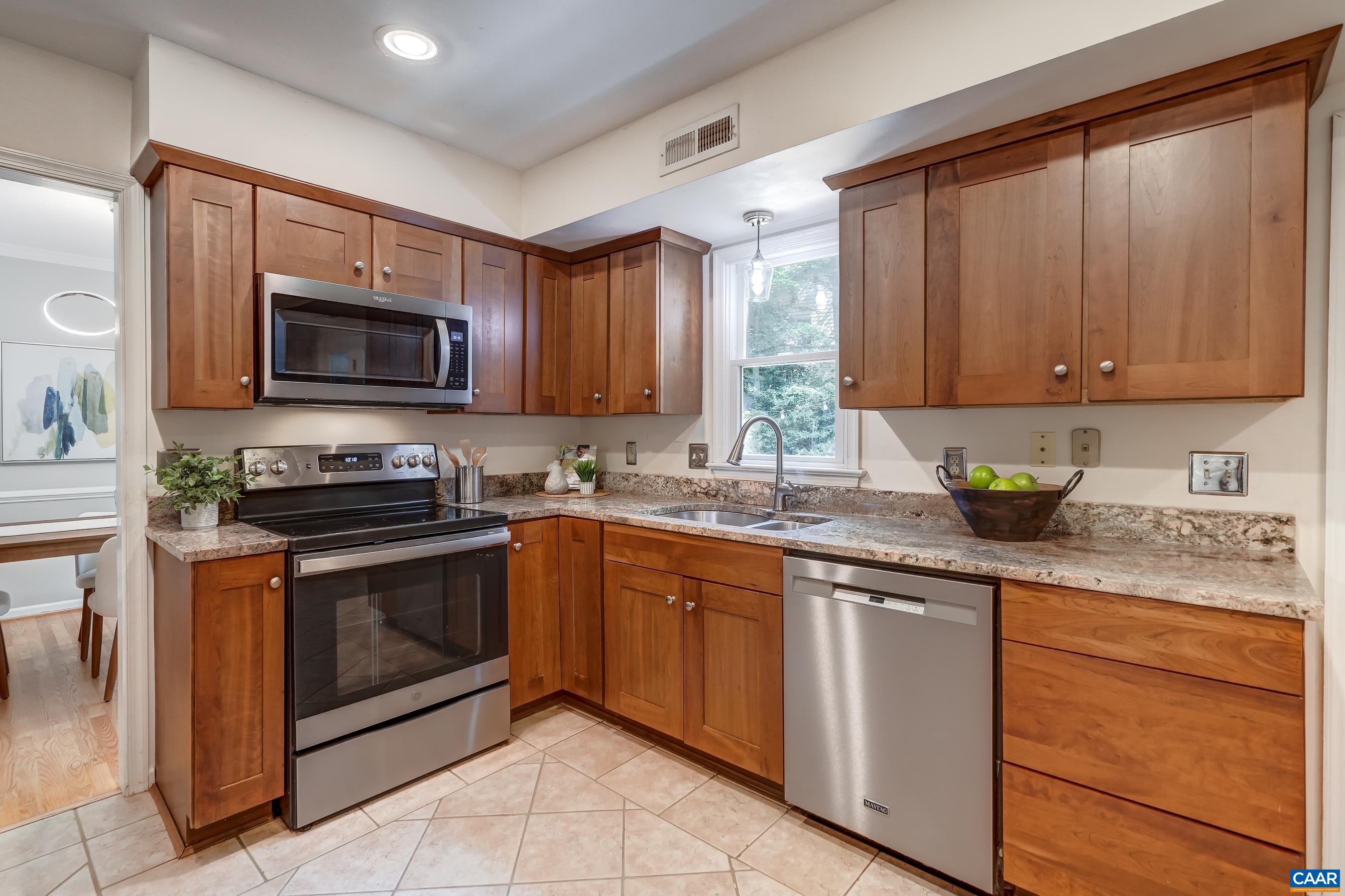 Modern gourmet kitchen features cherry cabinets and granite countertops. Modern gourmet kitchen features cherry cabinets and granite countertops.