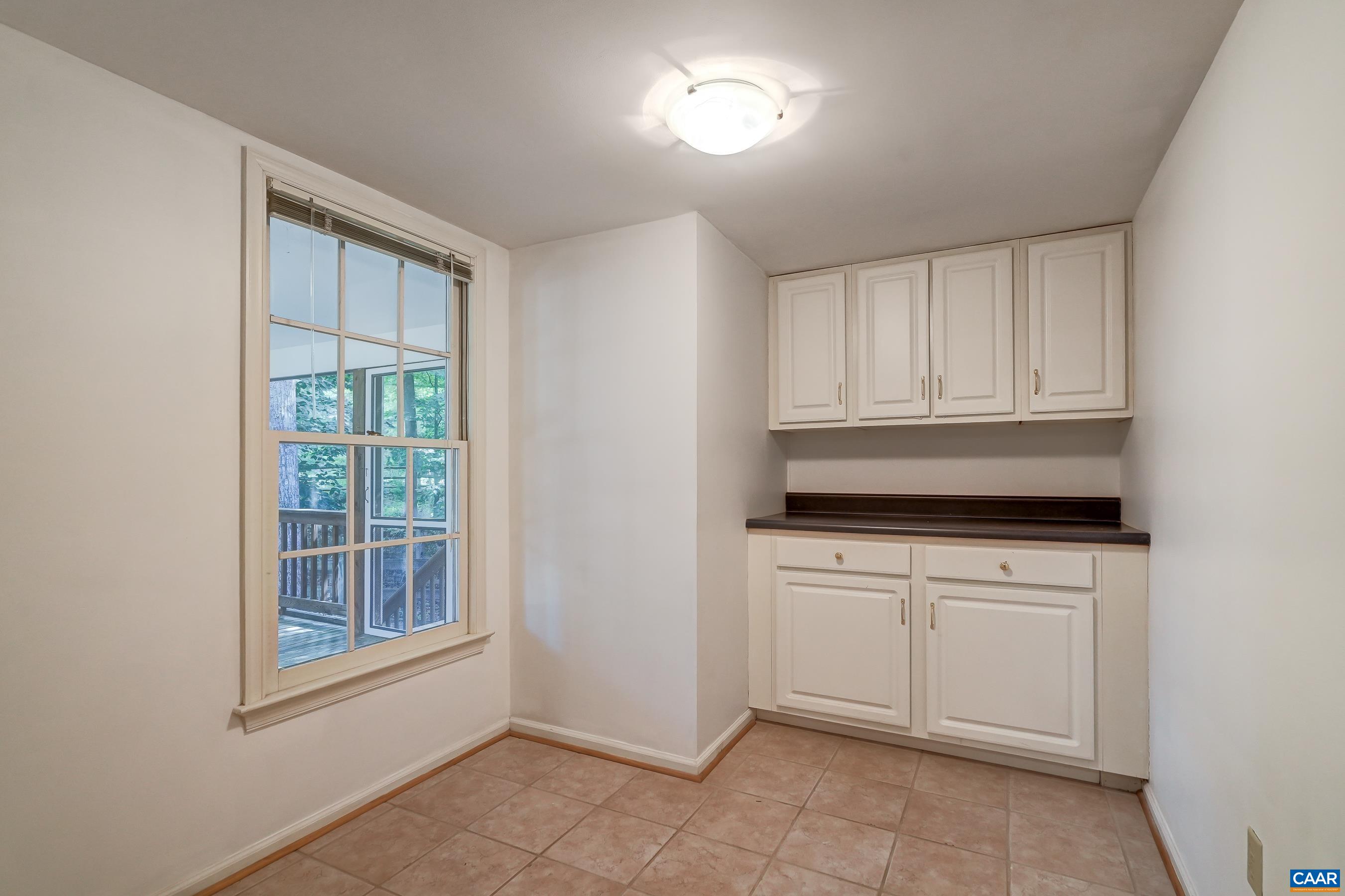 Main level laundry room features built-in cabinets. Main level laundry room features built-in cabinets.
