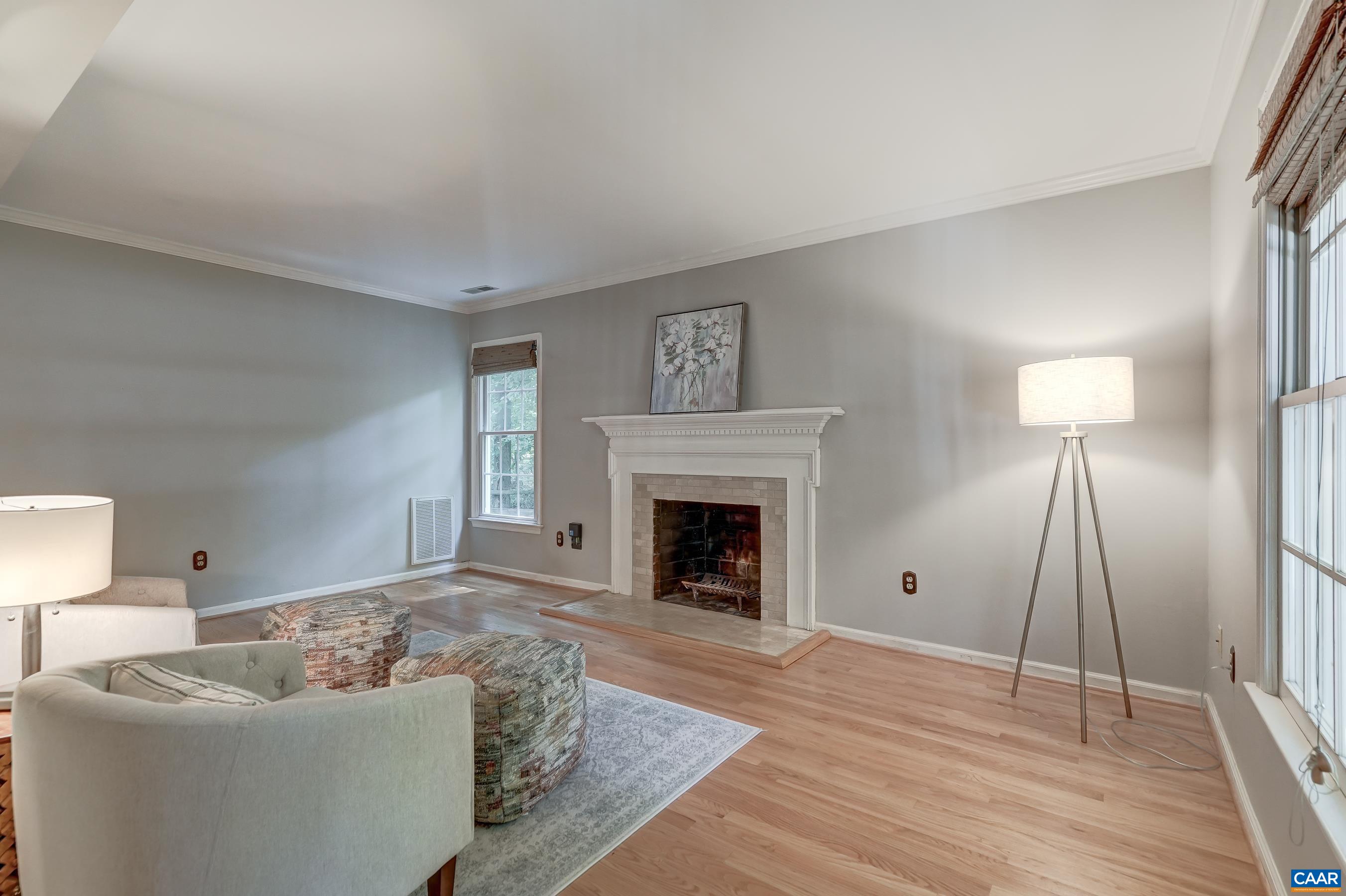 Large den with wood burning fireplace features an updated mantle and surround. Large den with wood burning fireplace features an updated mantle and surround.