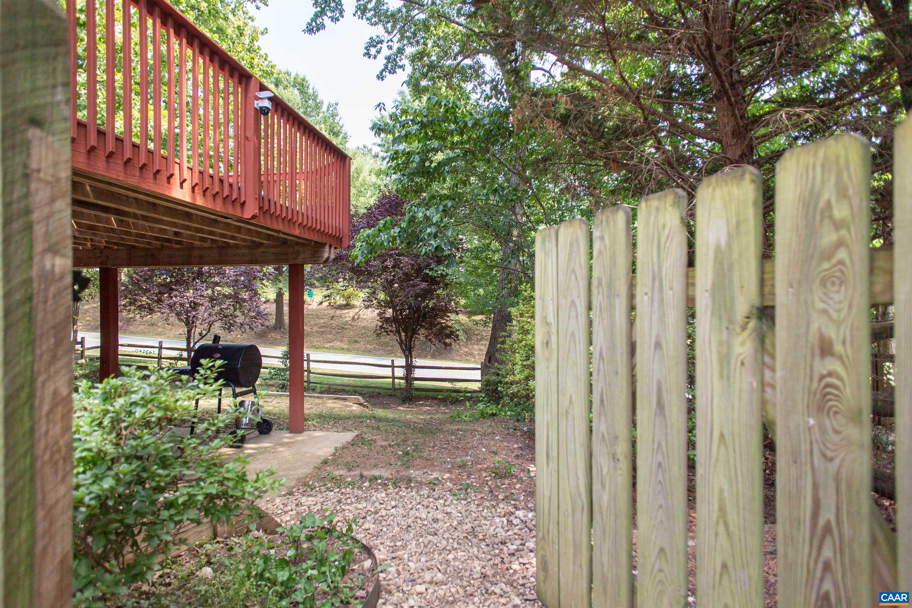 Fenced back yard offers pockets of wildflowers & mature trees. Fenced back yard offers pockets of wildflowers & mature trees.