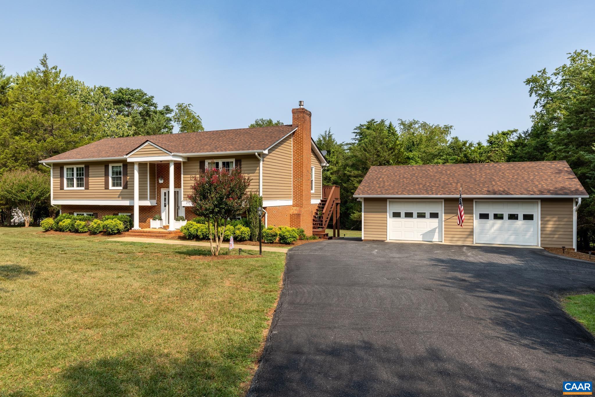 Private, picturesque country living at its finest! Stunning view showcasing a well-maintained home, expansive paved driveway, and a spacious detached garage/workshop, all surrounded by lush mature trees and a sprawling green lawn! Cypress siding is lovely