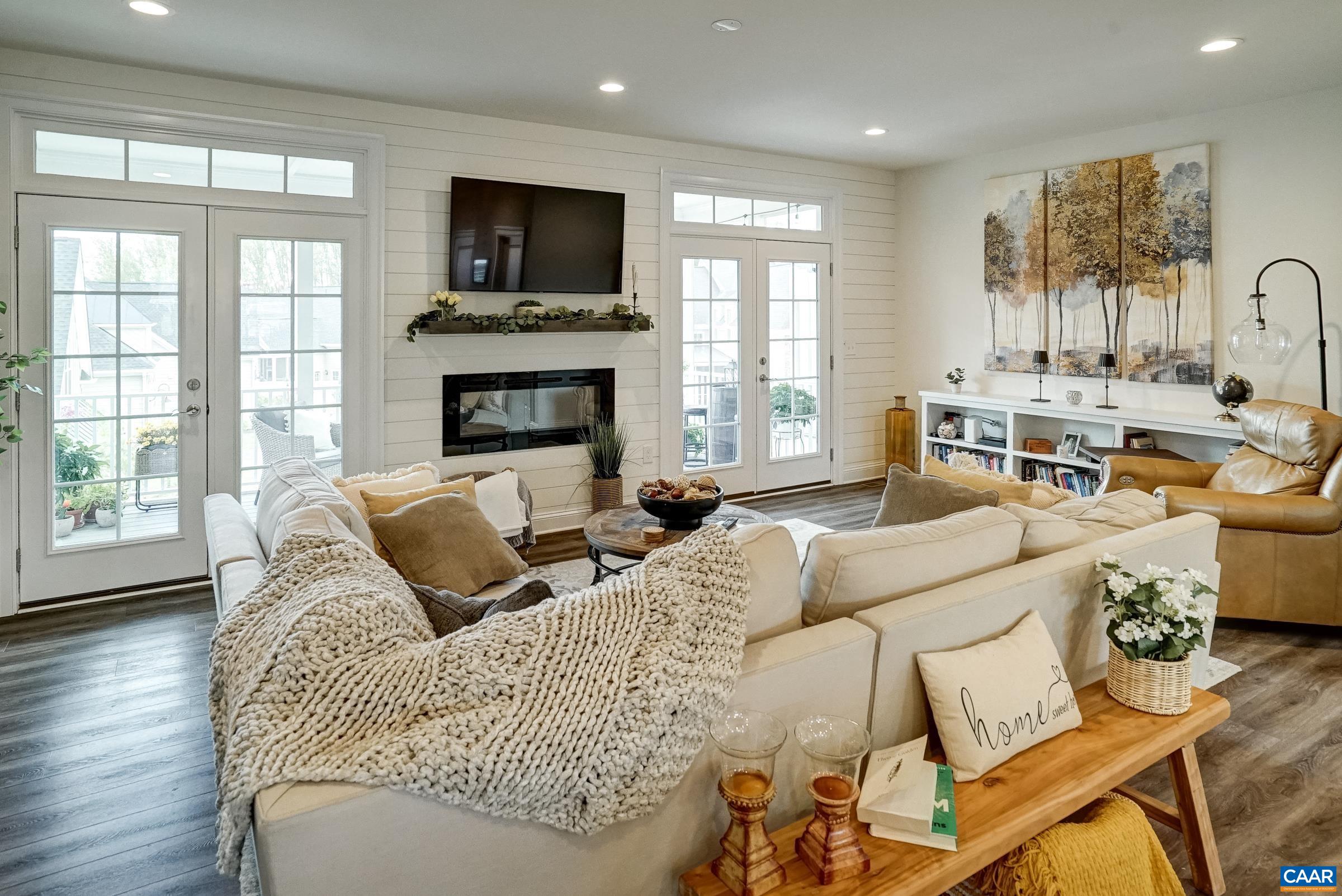 Great room features shiplap wall details, and built-in storage.