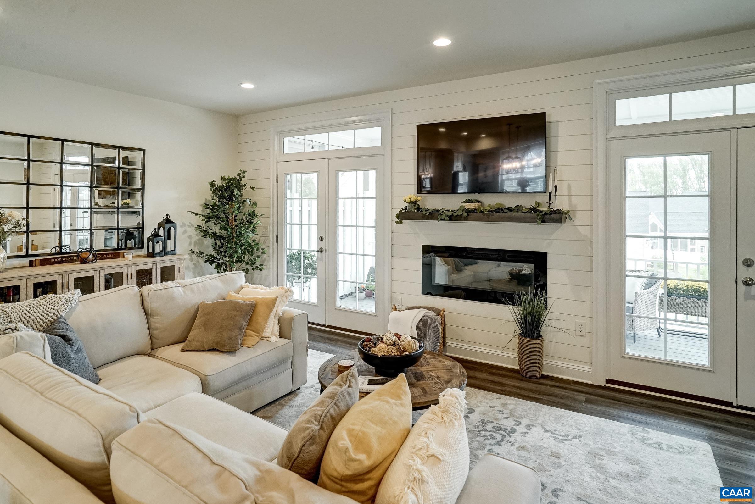 Double french doors lead to screened porch.