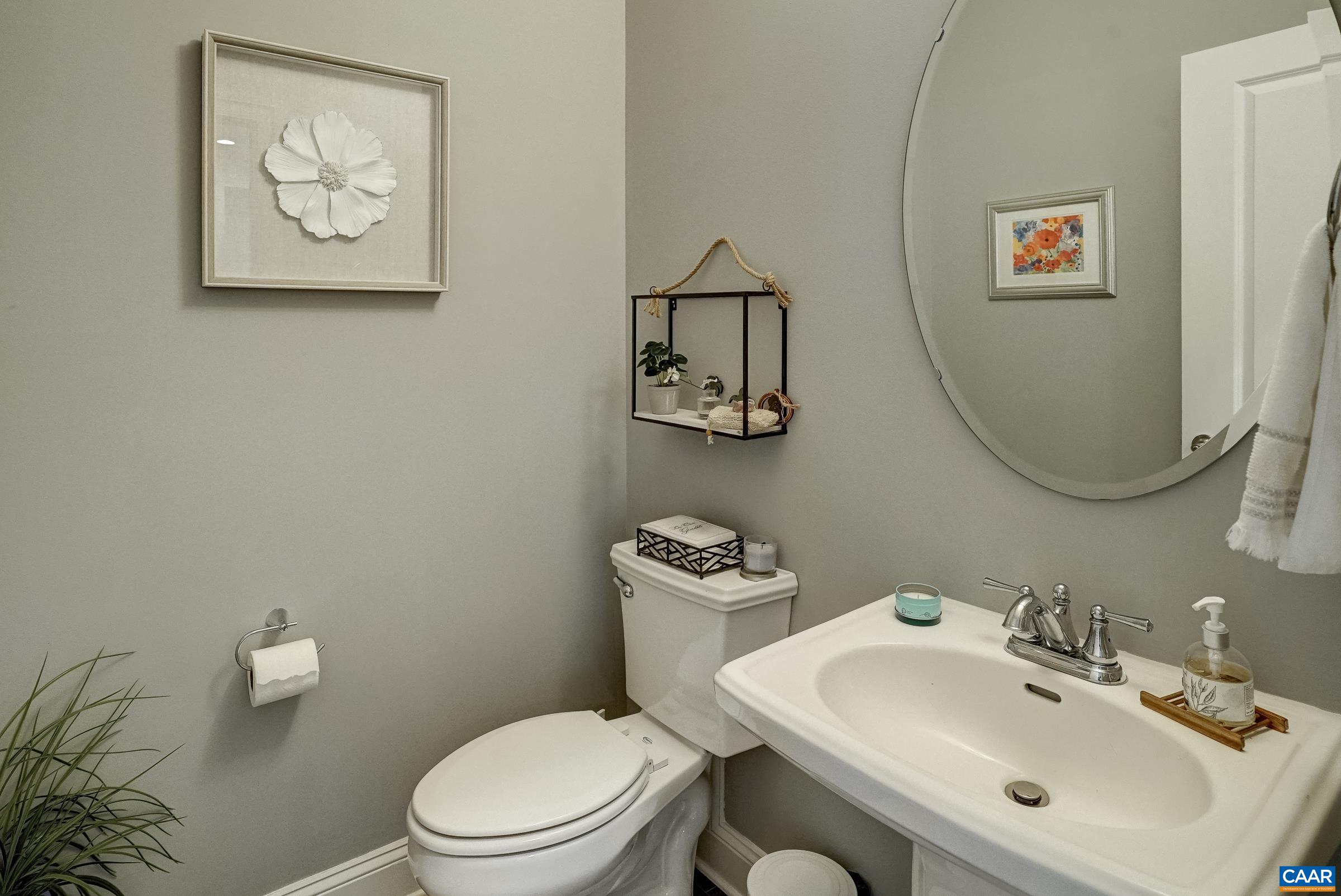Powder room features pedestal sink.