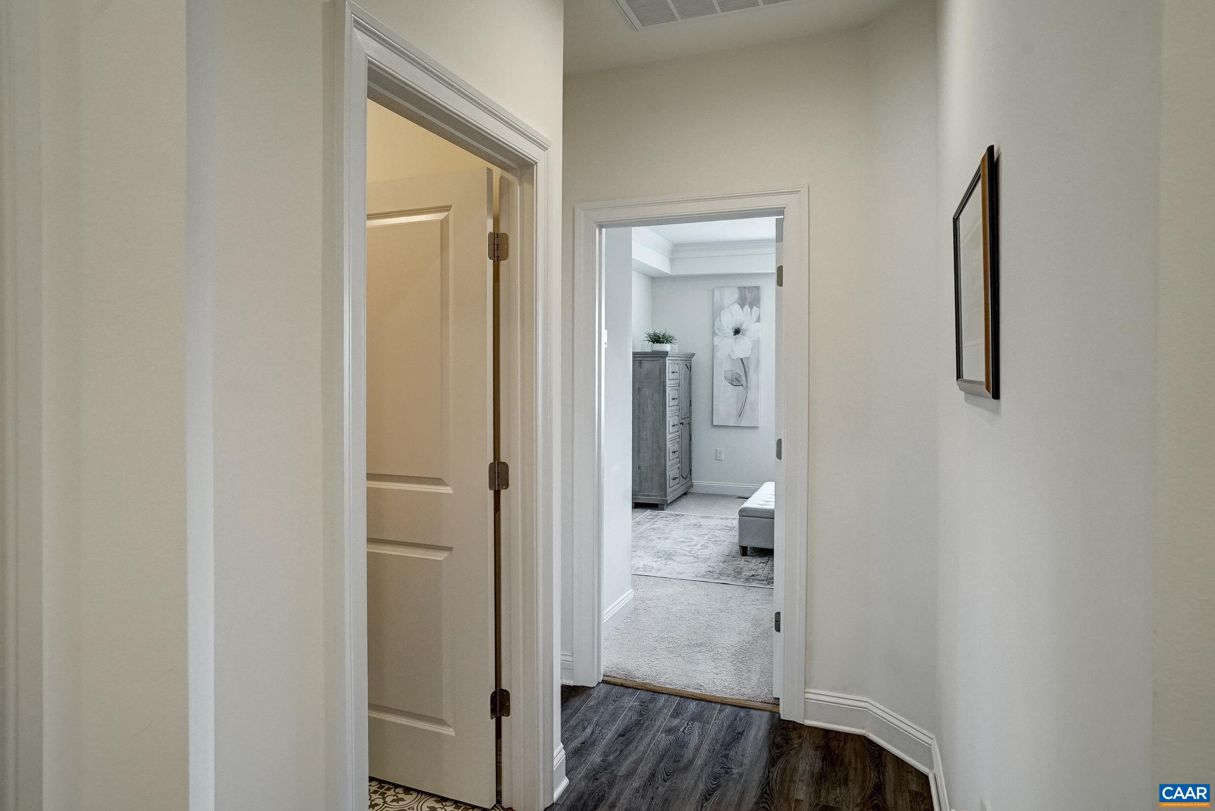 Luxury vinyl flooring continues in the hallway.