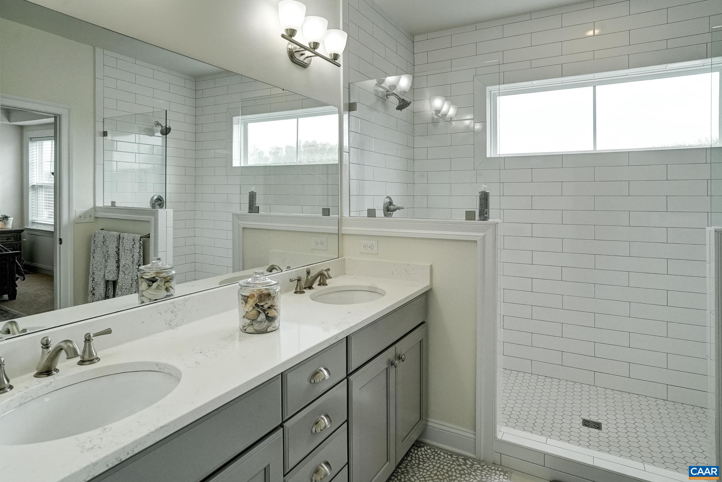 Primary bathroom features double sink vanity.