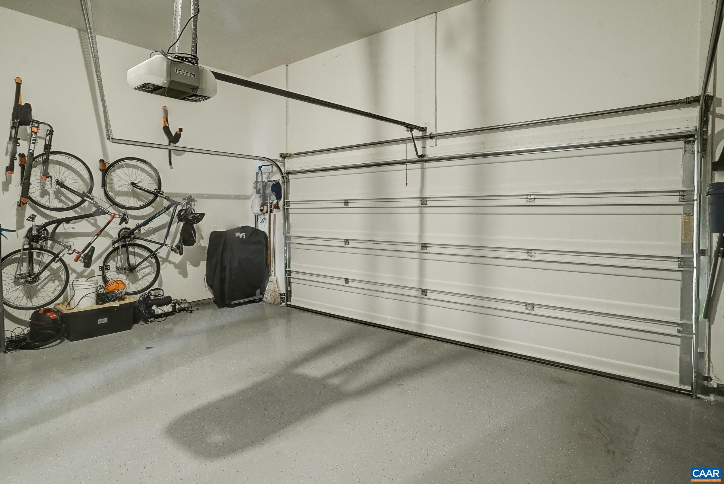 Two car garage features epoxy flooring.
