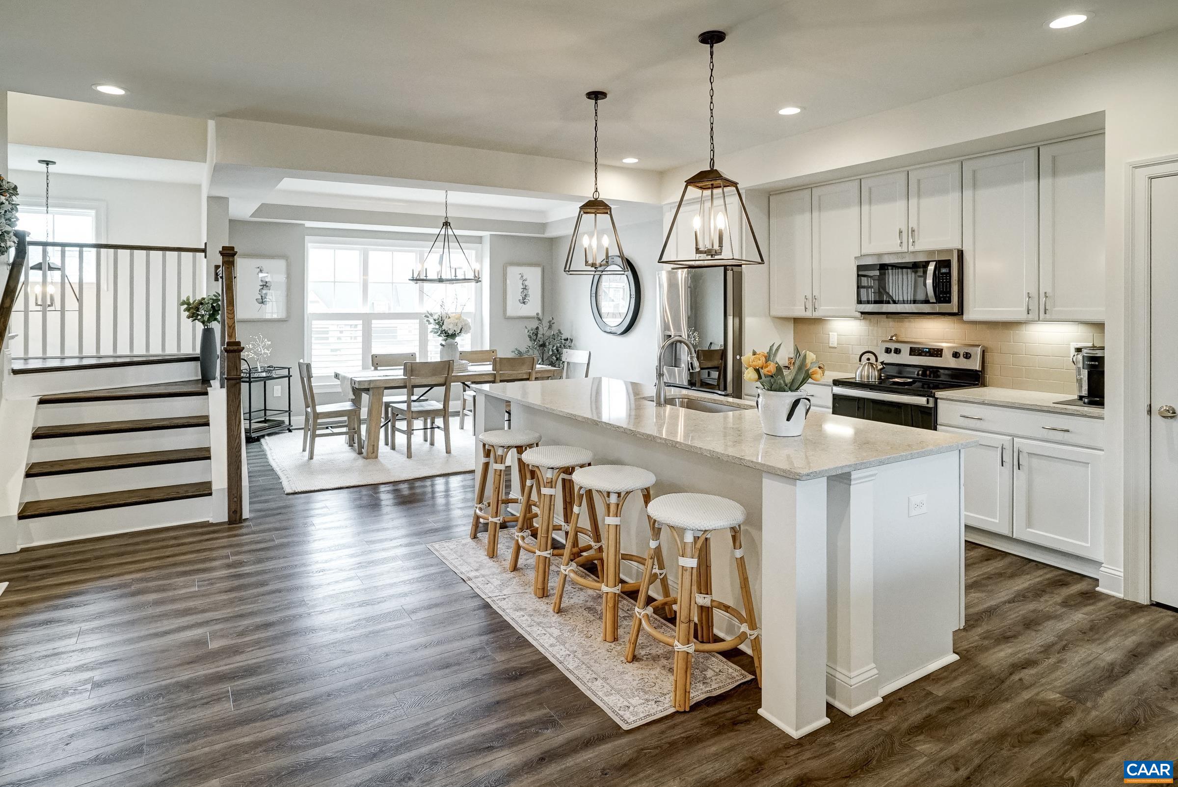 White cabinets, and stainless appliances including new refrigerator.
