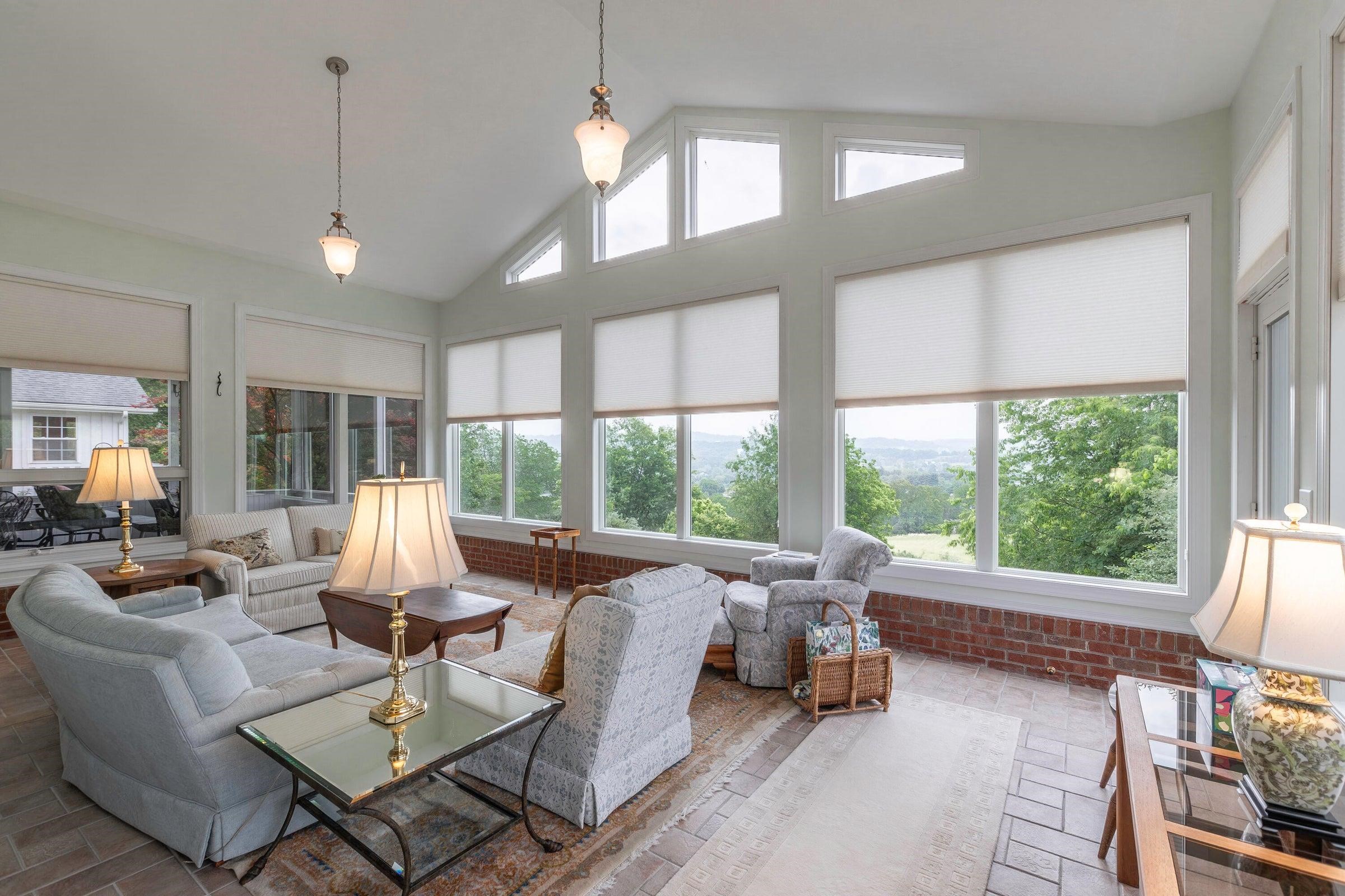 The gorgeous four-season sunroom is the perfect place to relax and take in the views year-round. The gorgeous four-season sunroom is the perfect place to relax and take in the views year-round.