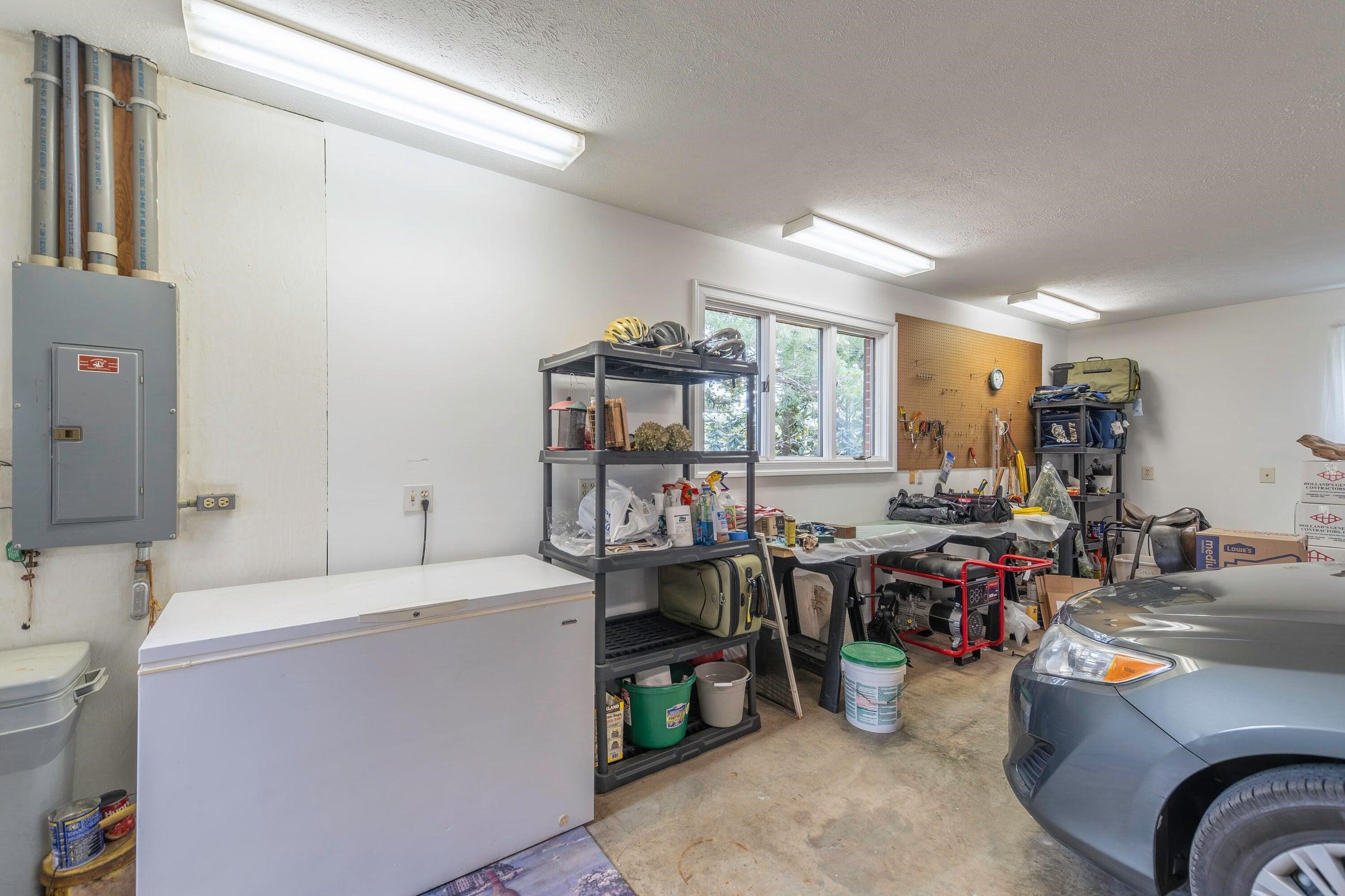 An oversized two-car garage provides ample storage and workspace. An oversized two-car garage provides ample storage and workspace.