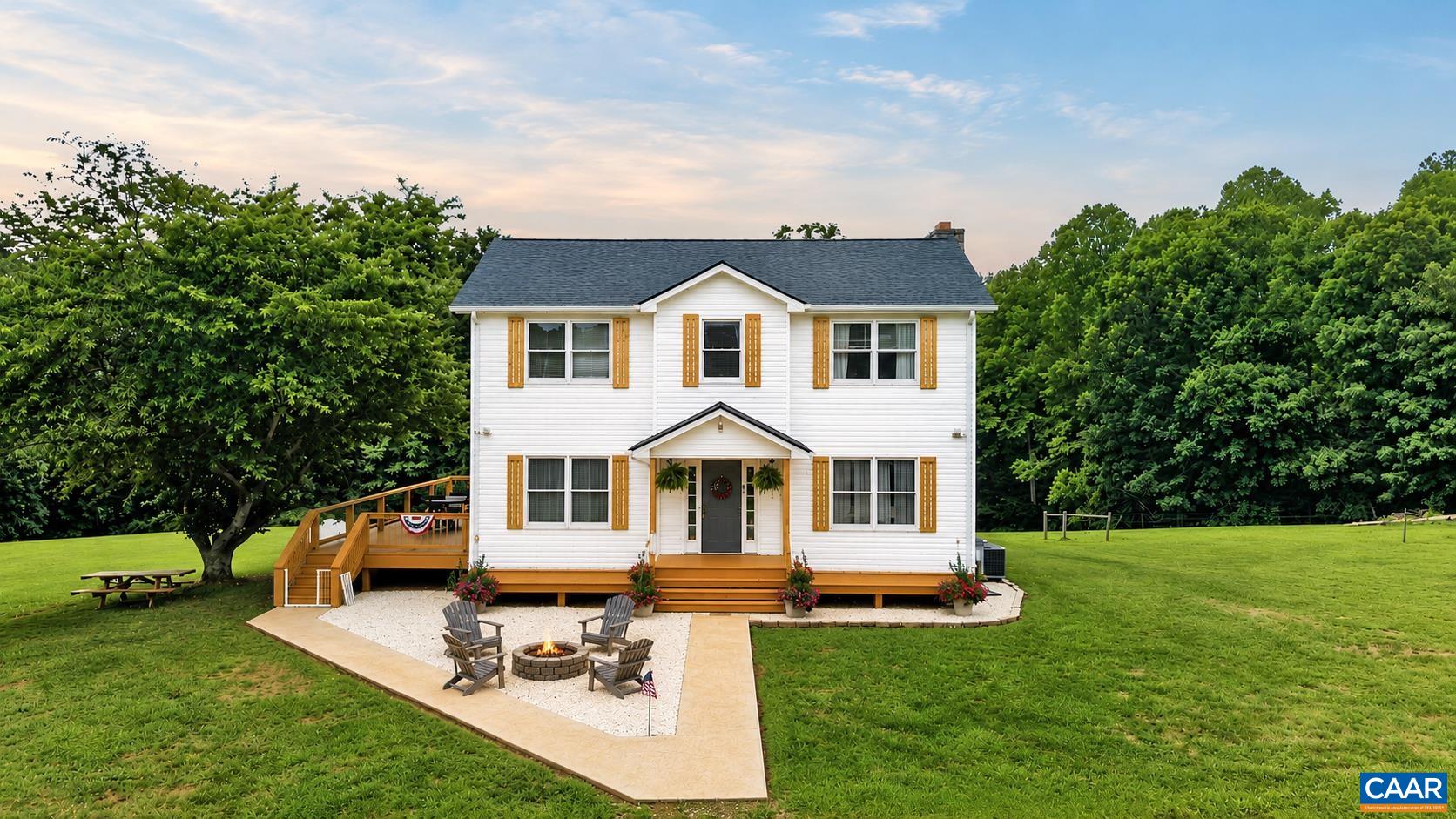 Enjoy country living in this charming farmhouse on almost 16 acres of beautiful, open pastureland.