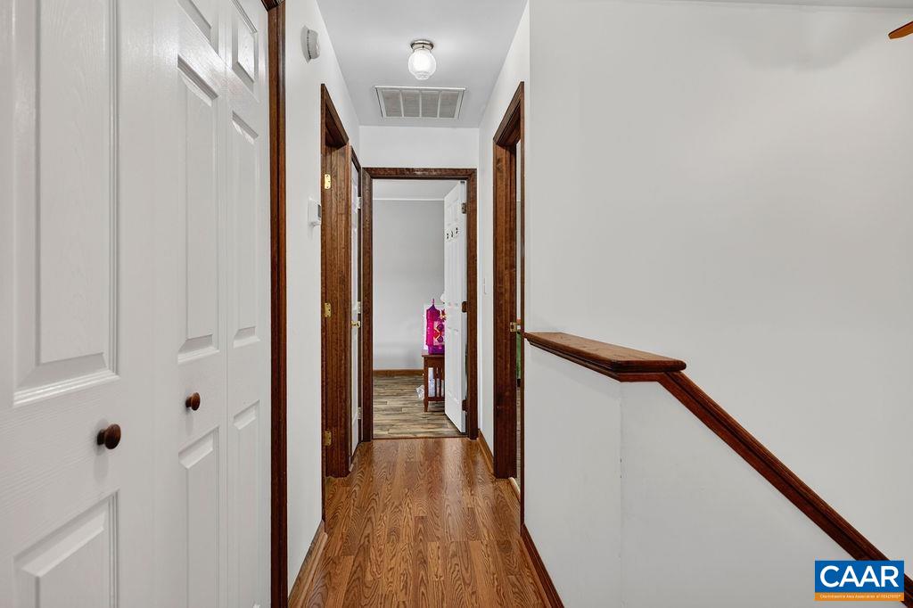 The primary suite, along with two guest bedrooms and a full bath, is located on the second floor.