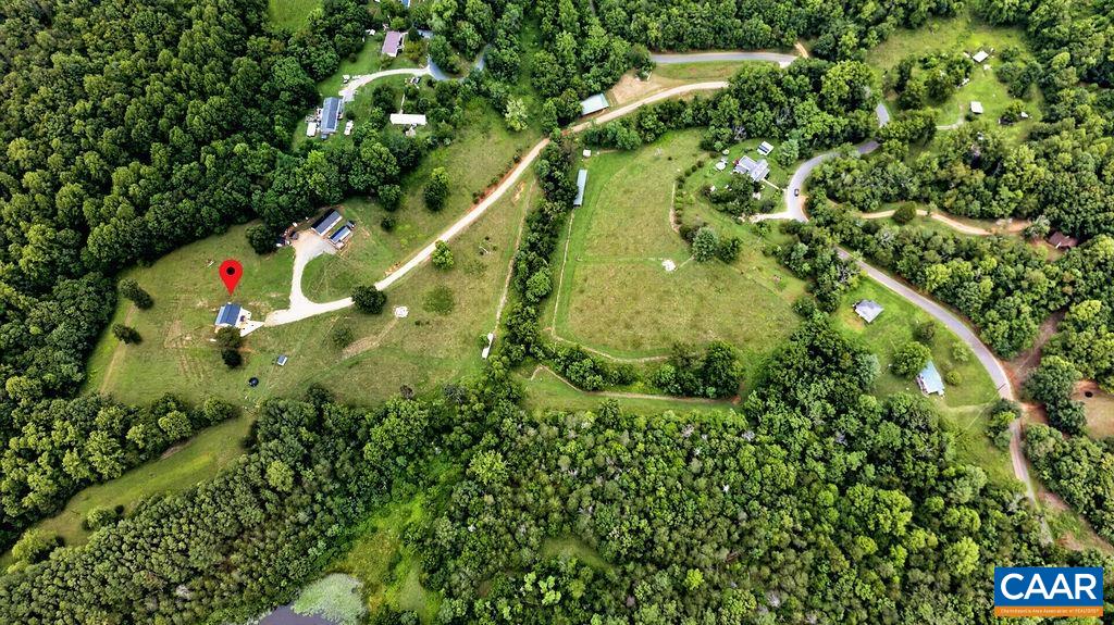 The property features three fenced pastures and three natural creeks, making it ideal for horses, livestock, or simply enjoying the beauty of the countryside.