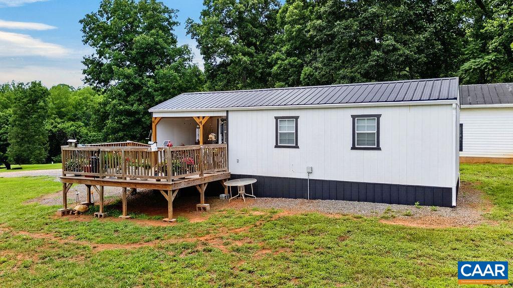 A charming guest cottage offers its own septic system, water service, Wi-Fi, heating and air conditioning, along with a lovely deck and covered front porch—ideal for guests, extended family, a home office, or a private studio.