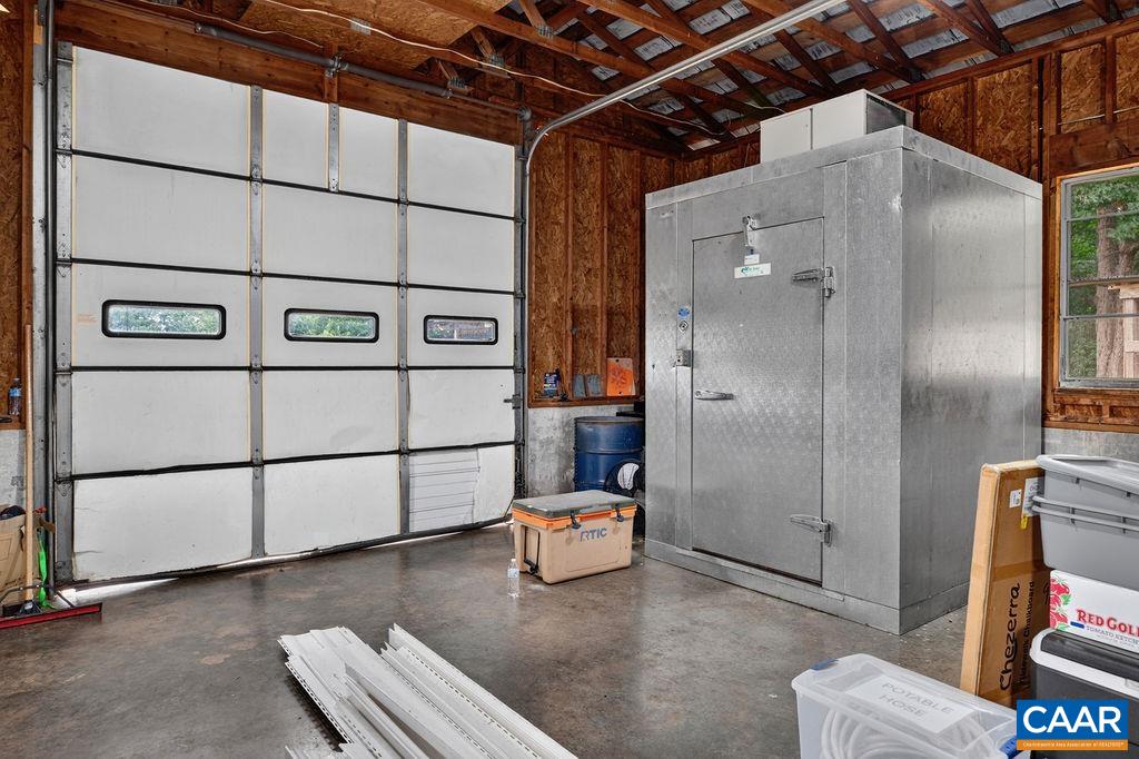 The walk-in freezer in the garage/ workshop conveys.