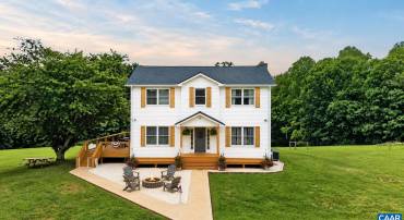 Enjoy country living in this charming farmhouse on almost 16 acres of beautiful, open pastureland.