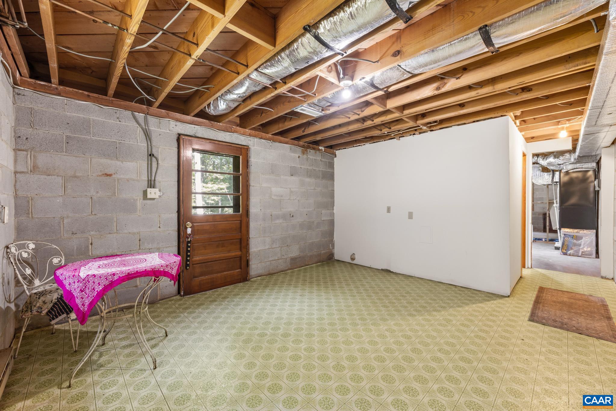 Featuring its own exterior entrance and abundant room for a variety of uses. With a bathroom already located at the back of the space and plumbing in place, this versatile area offers excellent potential for creating an additional living suite and kitchen