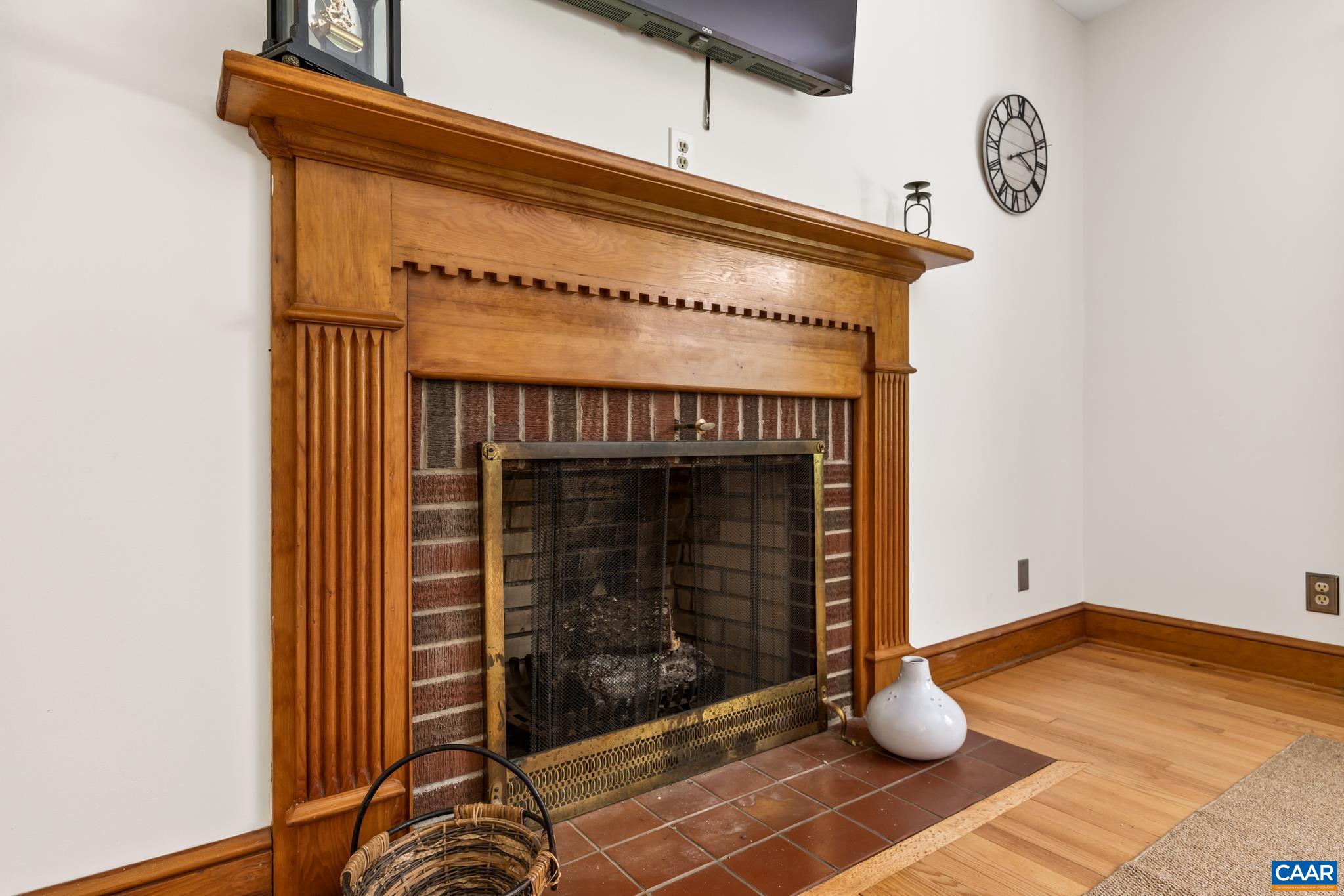 The woodburning fireplace serves as the living rooms central focal point, adding warmth, character and timeless appeal