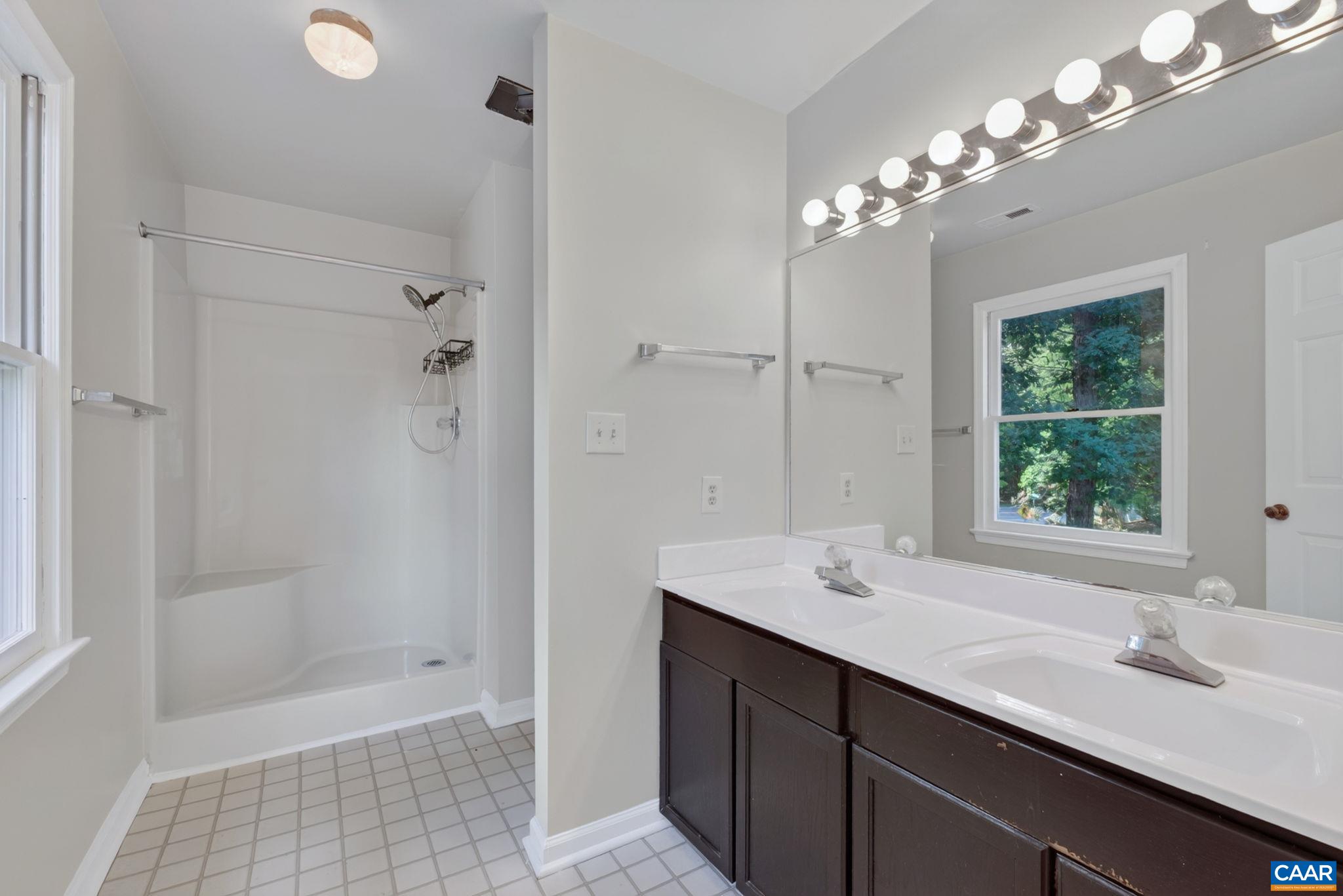 This en suite features stand up shower, toilet and double sinks.