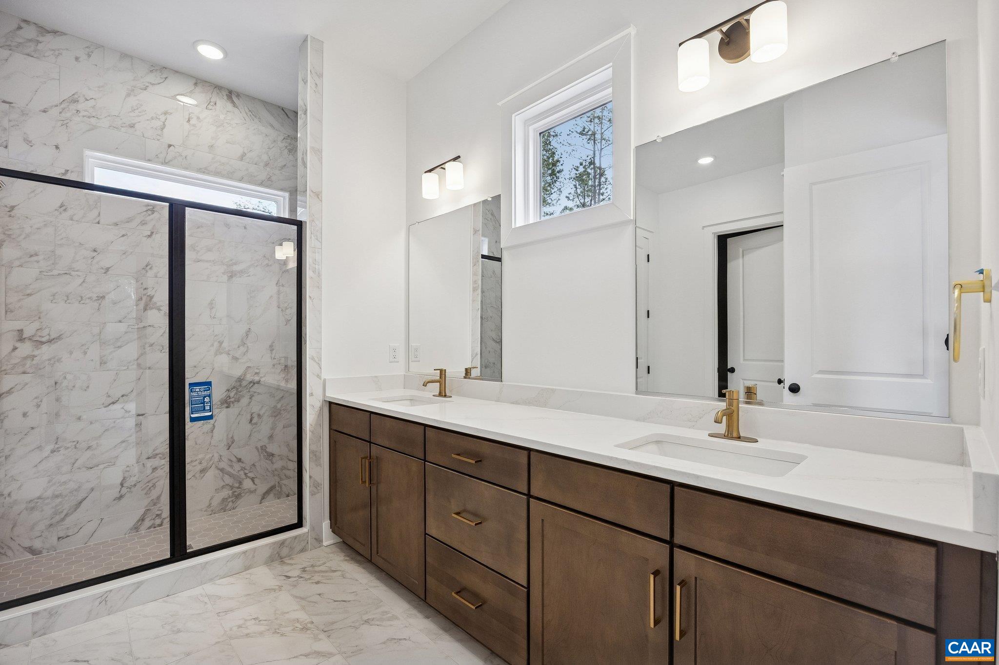 Dual Vanities, options for soaking tub or expanded shower, and frameless glass enclosure.