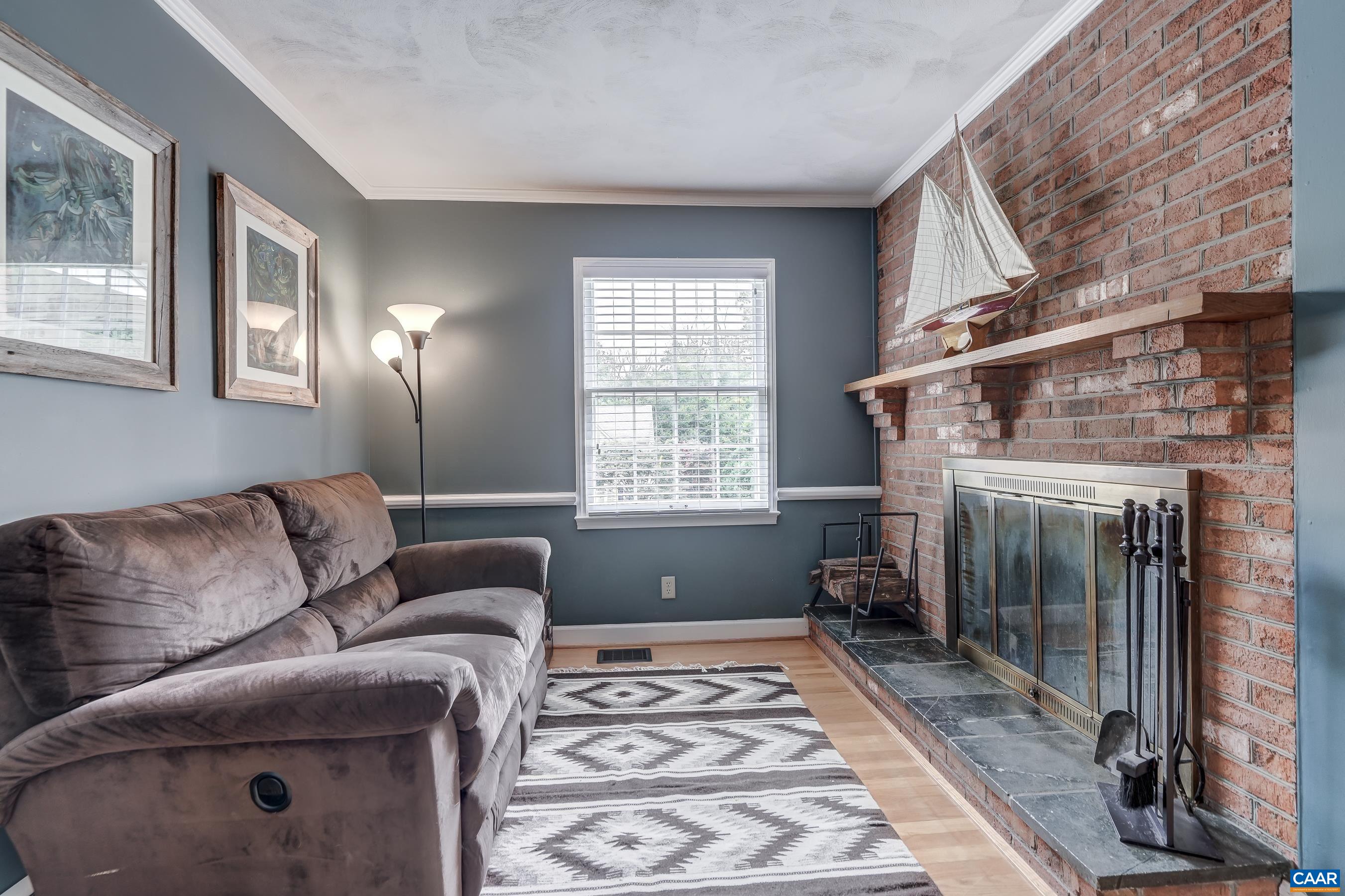 Cozy den with brick wood-burning fireplace Cozy den with brick wood-burning fireplace