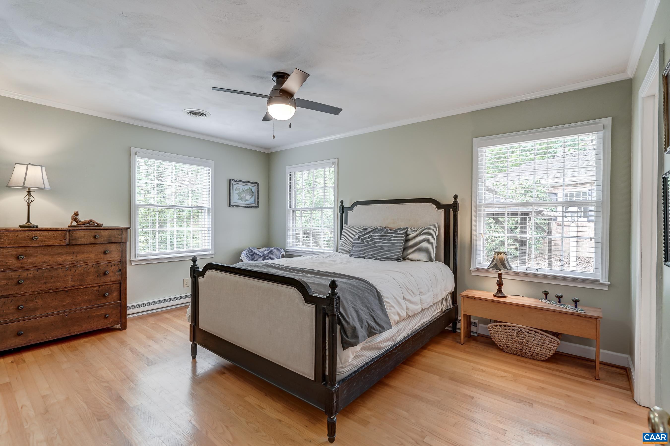 Primary bedroom on main level features ceiling fan. Primary bedroom on main level features ceiling fan.