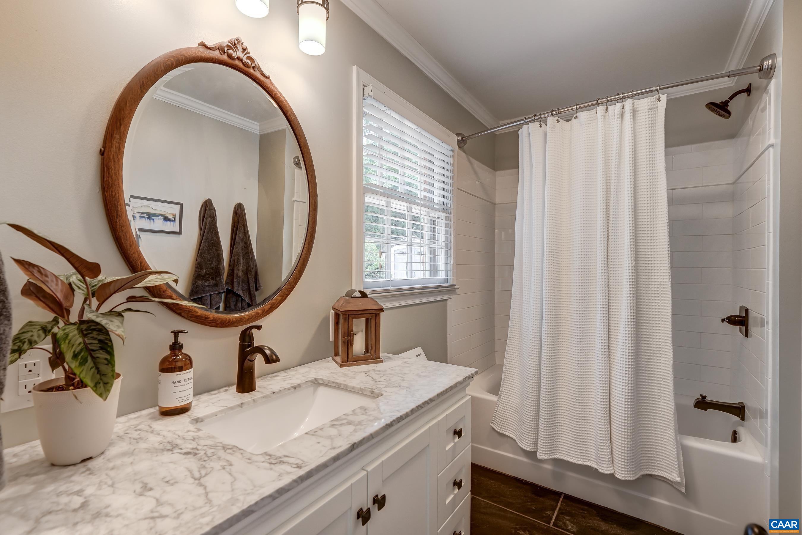 Remodeled ensuite bathroom boasts a marble-look vanity and tub/shower combo with oil rubbed bronze fixtures. Remodeled ensuite bathroom boasts a marble-look vanity and tub/shower combo with oil rubbed bronze fixtures.