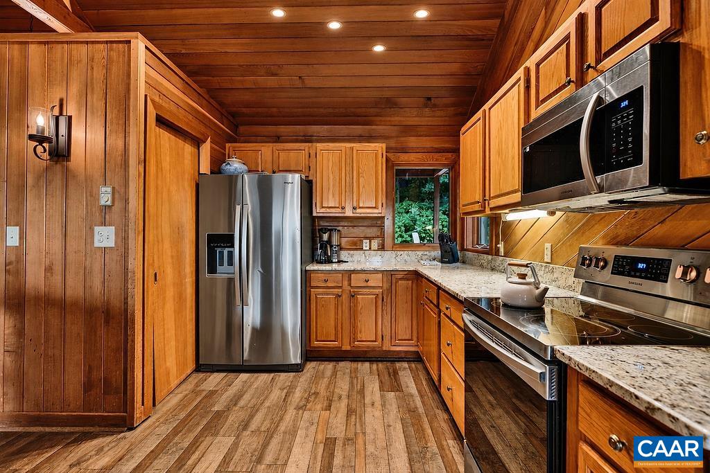 The spacious kitchen is equipped with granite countertops, stainless steel appliances, and a pantry for ample storage. The spacious kitchen is equipped with granite countertops, stainless steel appliances, and a pantry for ample storage.