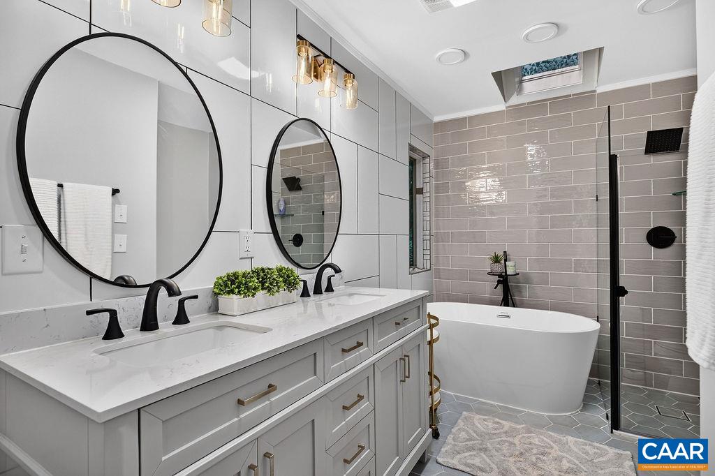 Beautifully renovated, the large main-level bathroom is both stylish and inviting. Beautifully renovated, the large main-level bathroom is both stylish and inviting.