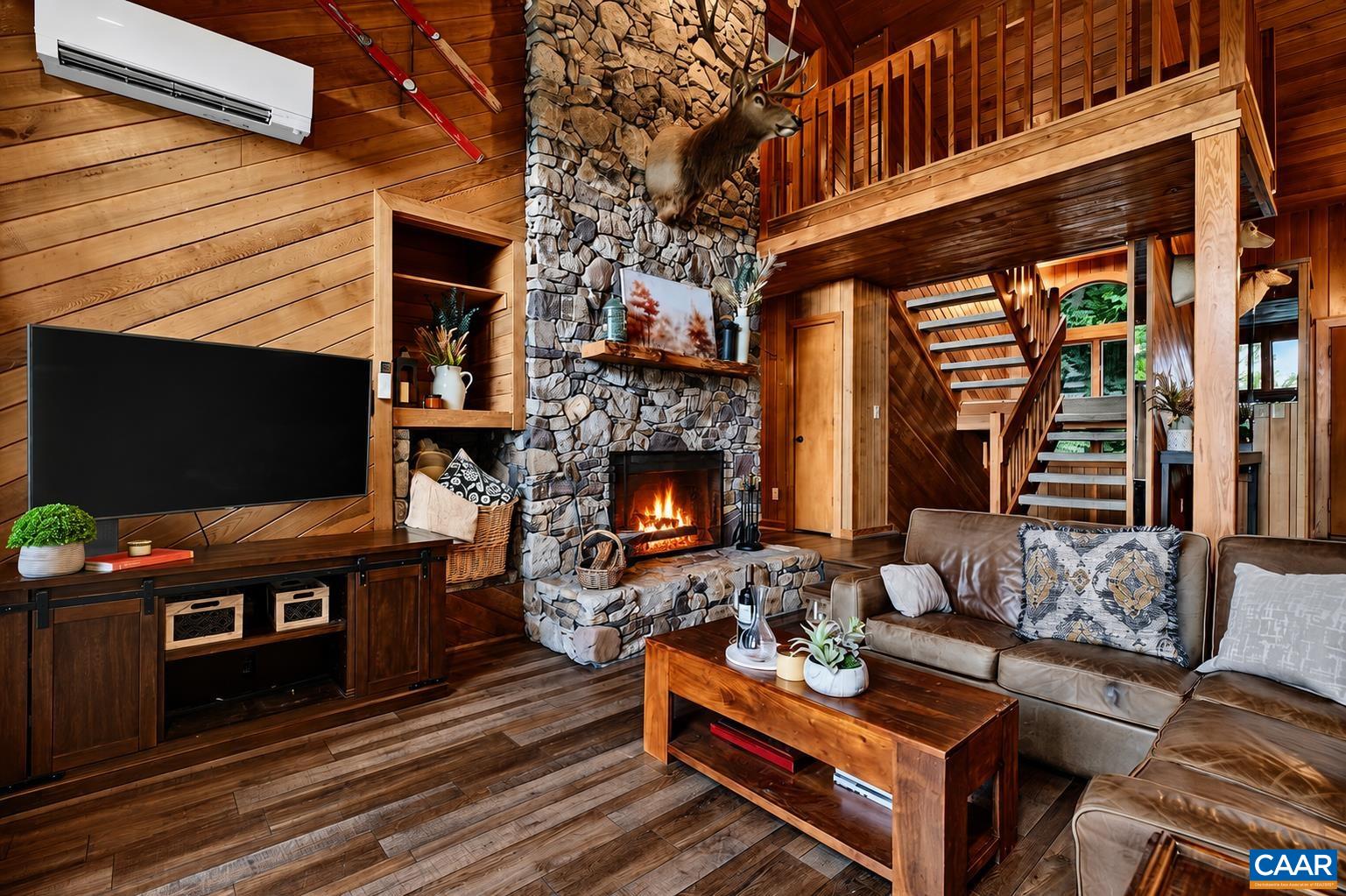 A stunning floor-to-ceiling stone, wood-burning fireplace serves as the dramatic focal point of the gorgeous great room. A stunning floor-to-ceiling stone, wood-burning fireplace serves as the dramatic focal point of the gorgeous great room.