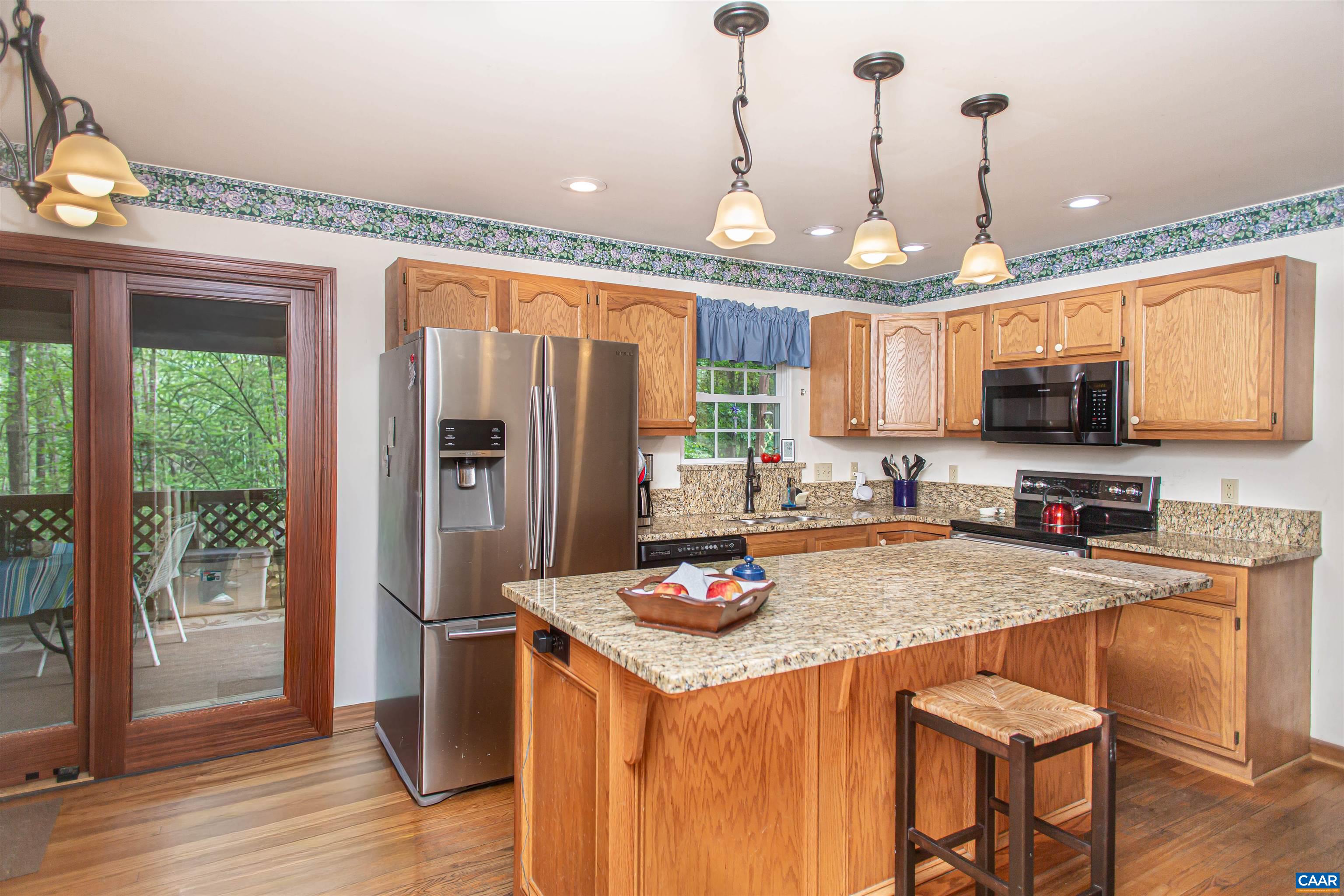The kitchen opens to the screened porch. The kitchen opens to the screened porch.