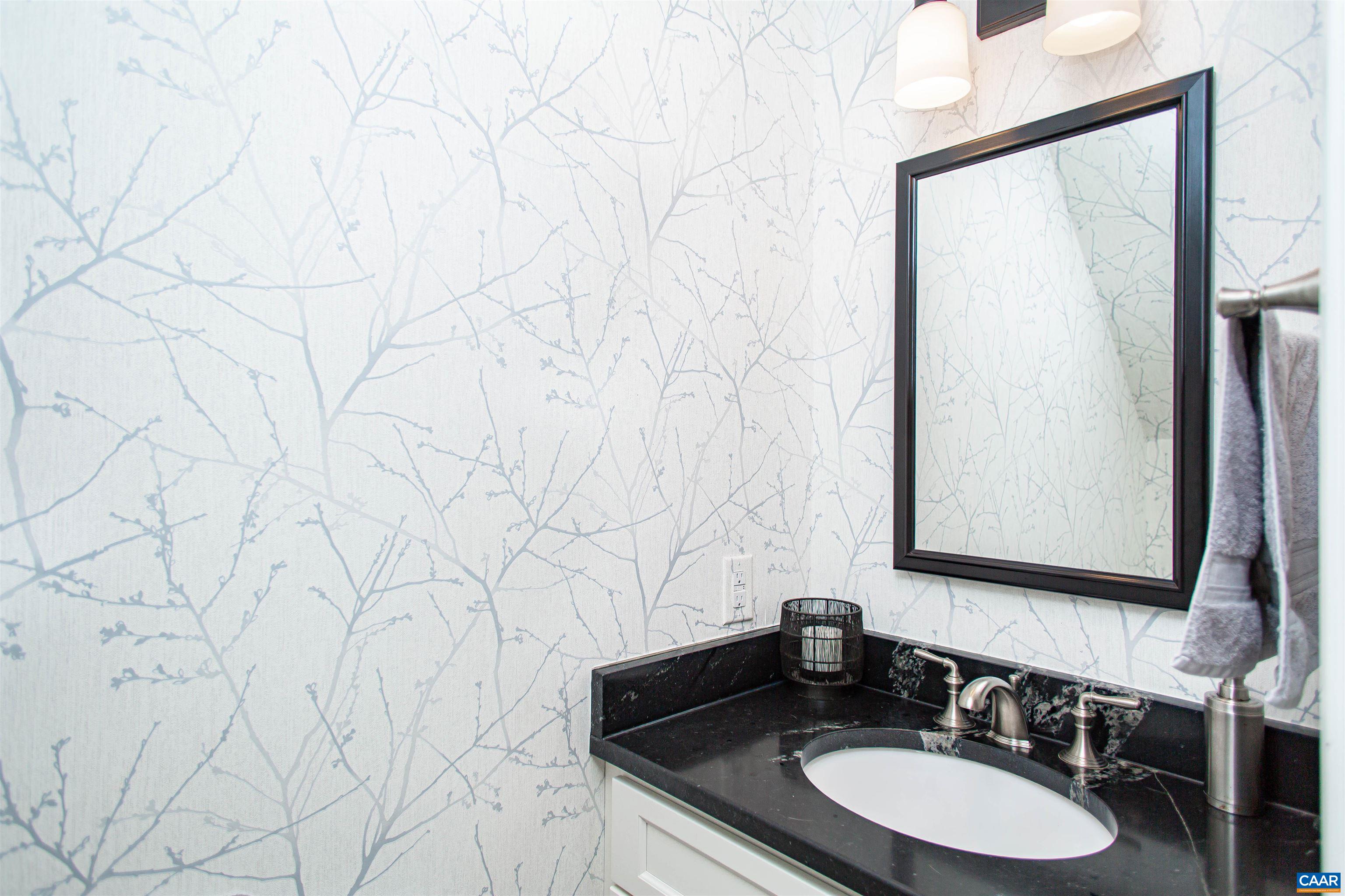 And an updated half-bath with grab bars to complete the first floor. And an updated half-bath with grab bars to complete the first floor.