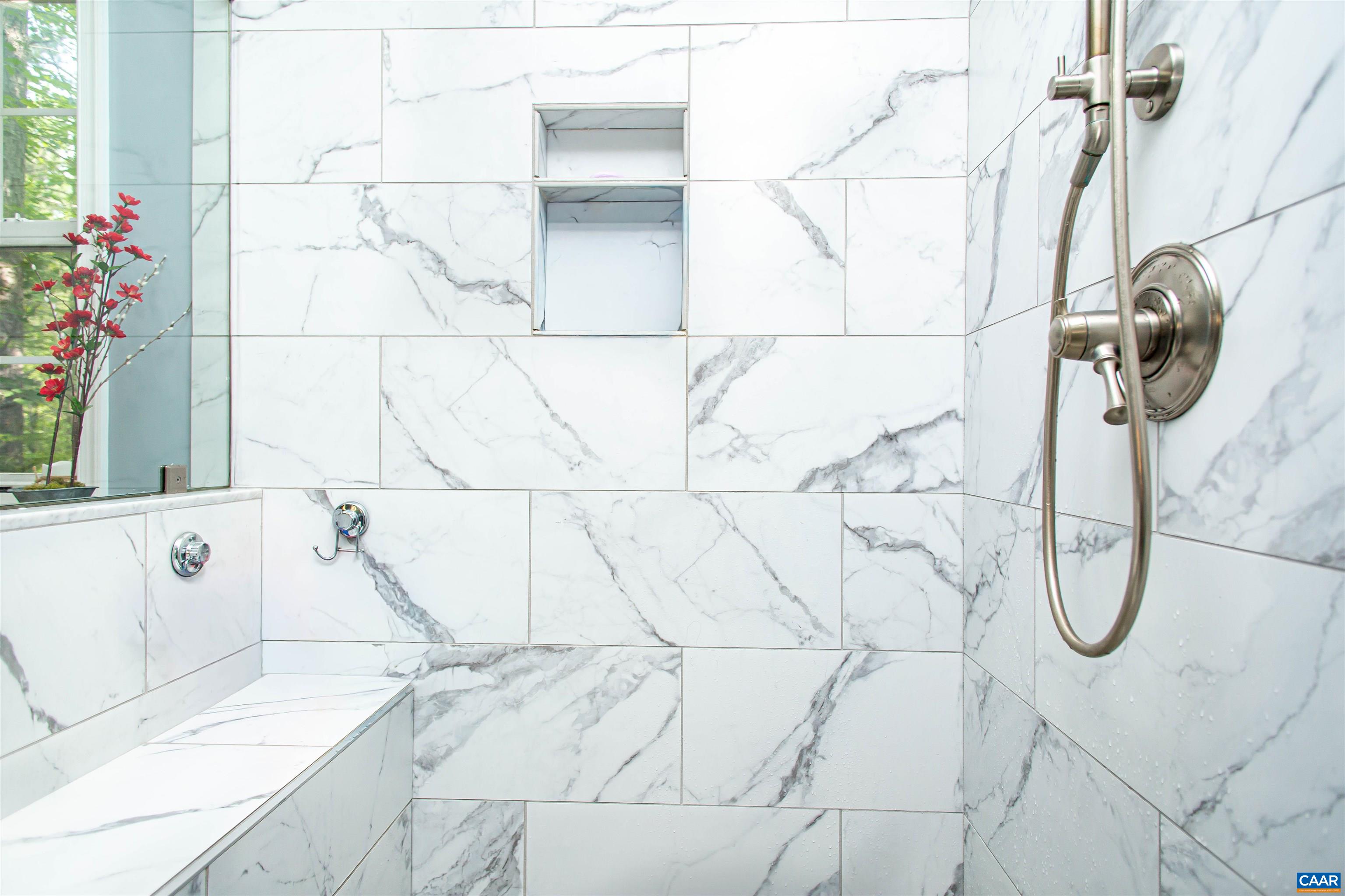 Tiled shower with glass doors. Tiled shower with glass doors.