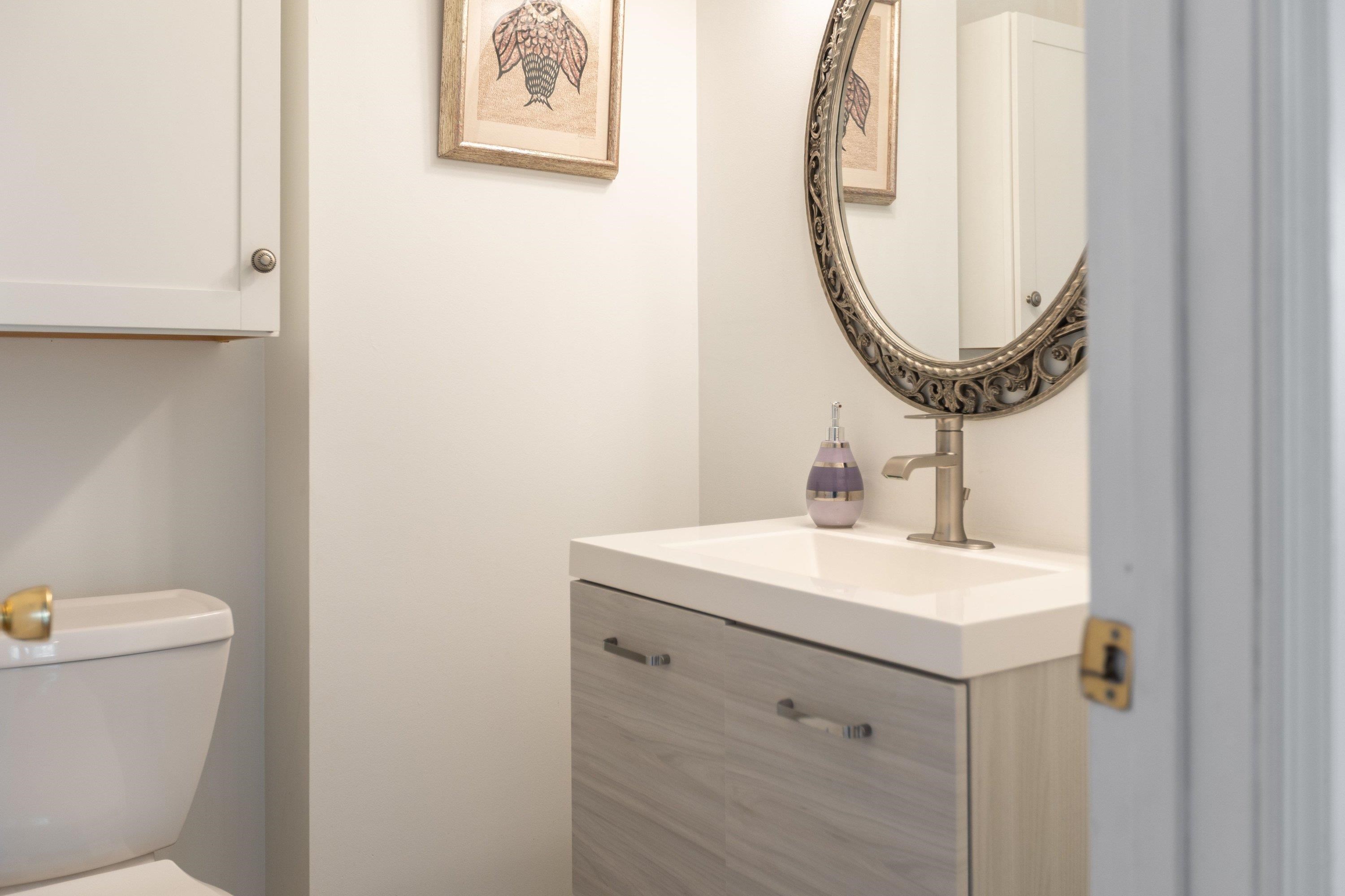 The powder bath features storage with cabinetry and is convenient to the living areas of the home. The powder bath features storage with cabinetry and is convenient to the living areas of the home.