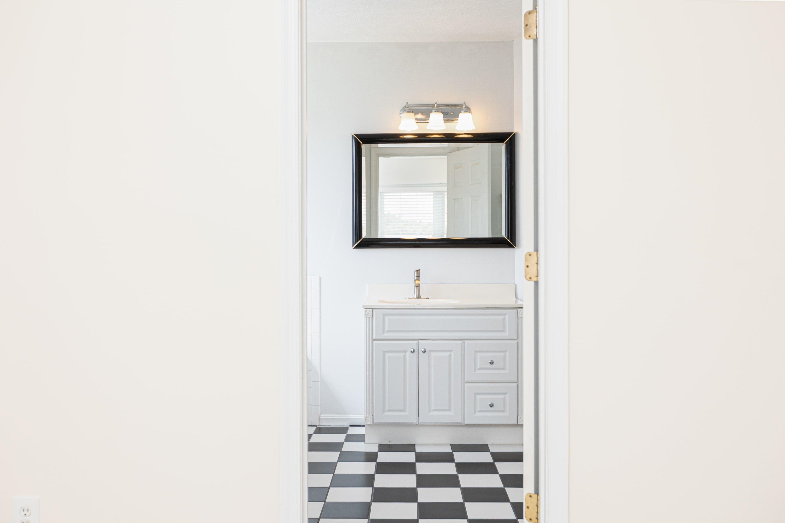This full bathroom offers dual vanities and a vanity with storage. This space features tile flooring and a bathtub with walk-in shower space. This full bathroom offers dual vanities and a vanity with storage. This space features tile flooring and a bathtub with walk-in shower space.