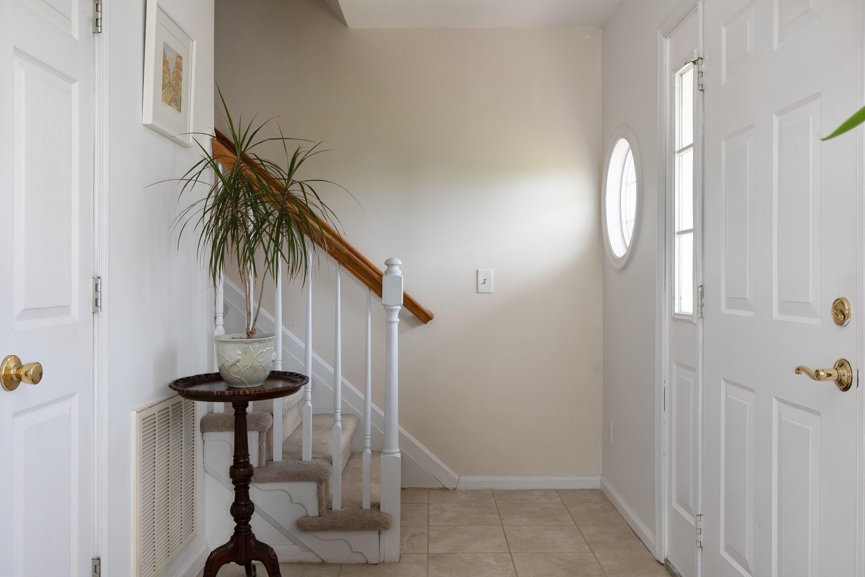 The foyer space features an open concept to the staircase leading to the upper level of the home, a living room space, and hallway leading to the kitchen of the home. The foyer space features an open concept to the staircase leading to the upper level of the home, a living room space, and hallway leading to the kitchen of the home.