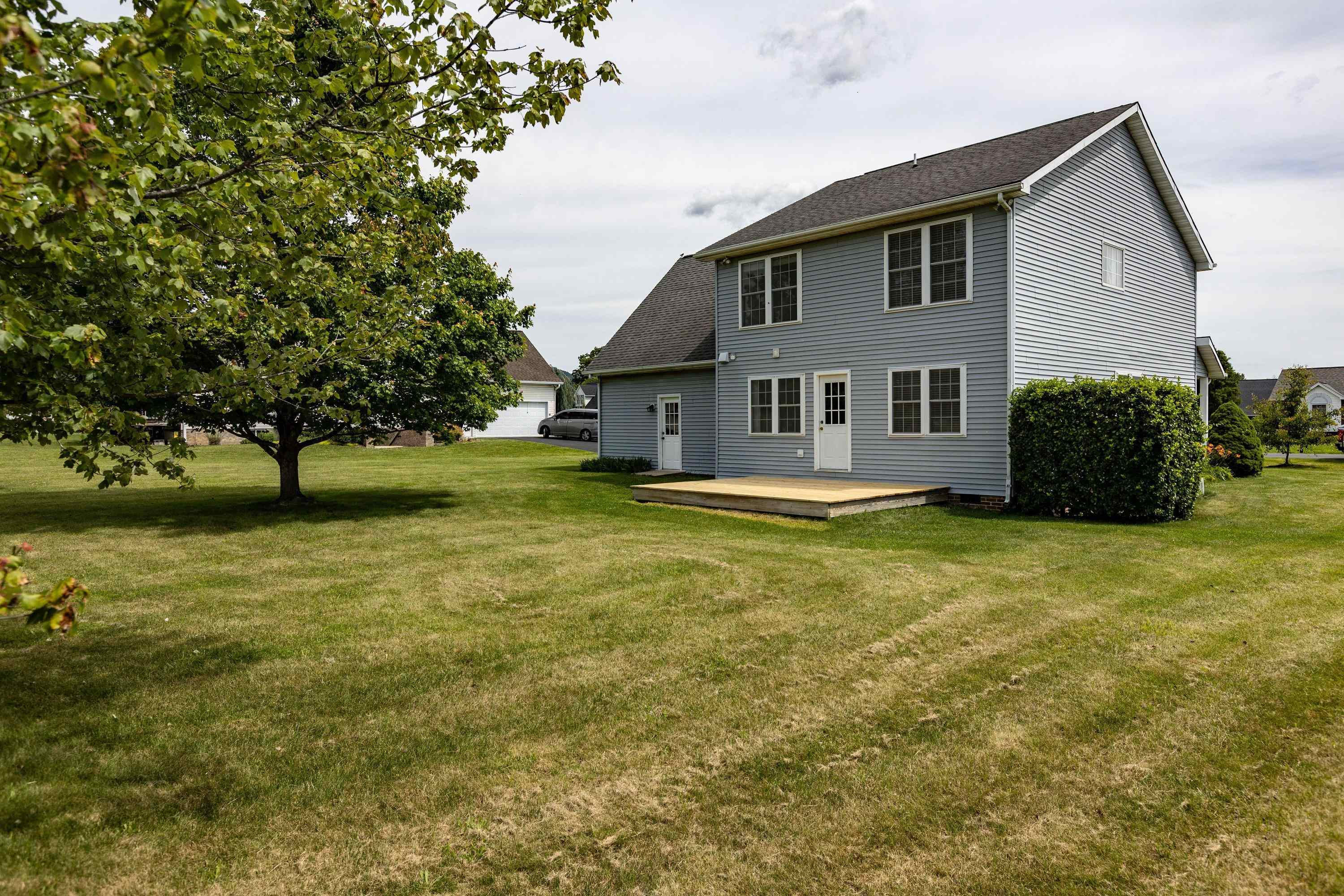 The back view of the home highlights the spacious, mostly level yard, extensive landscapting, mature trees, and much more! The back view of the home highlights the spacious, mostly level yard, extensive landscapting, mature trees, and much more!