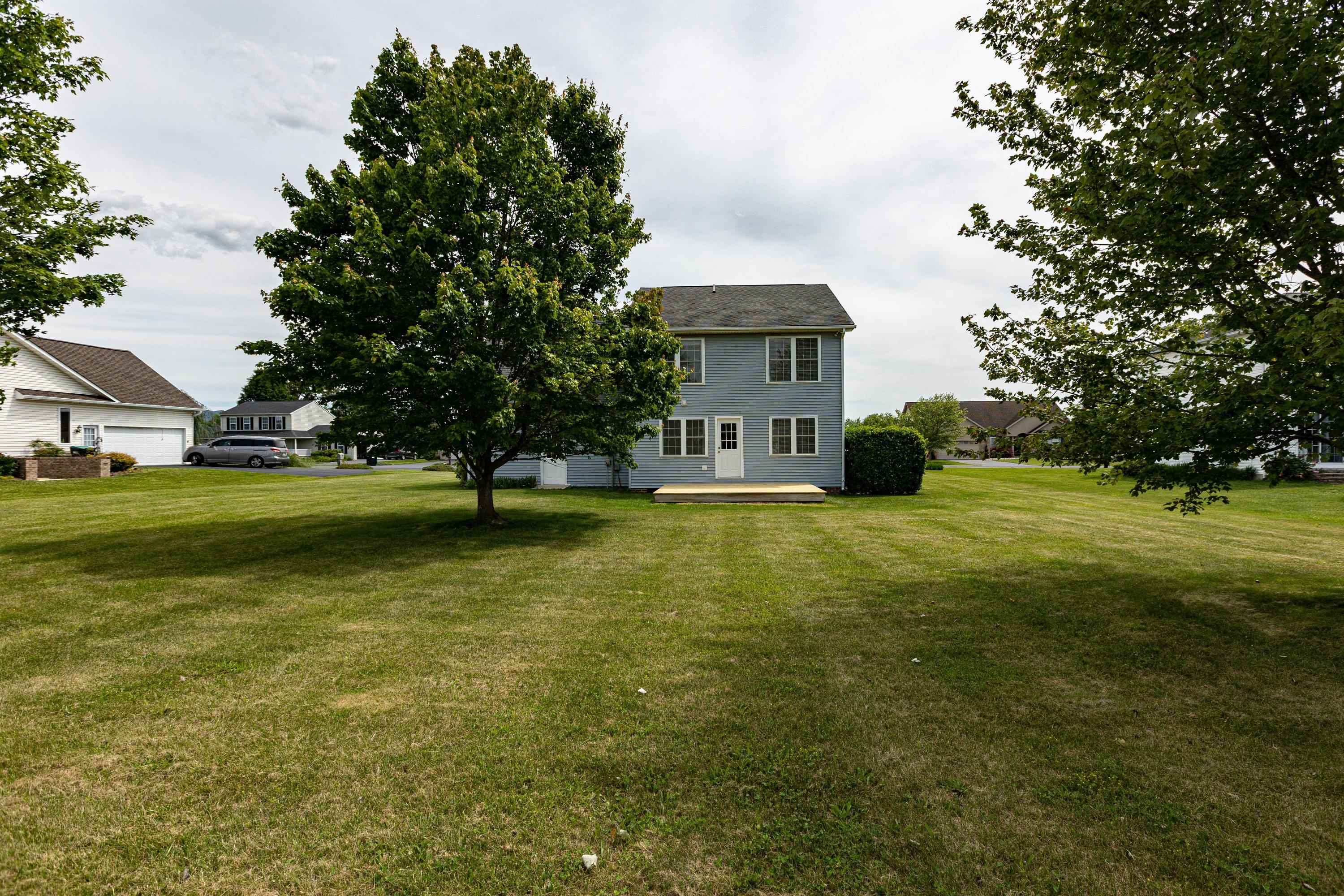 The back view of the home highlights the spacious, mostly level yard, extensive landscapting, mature trees, and much more! The back view of the home highlights the spacious, mostly level yard, extensive landscapting, mature trees, and much more!
