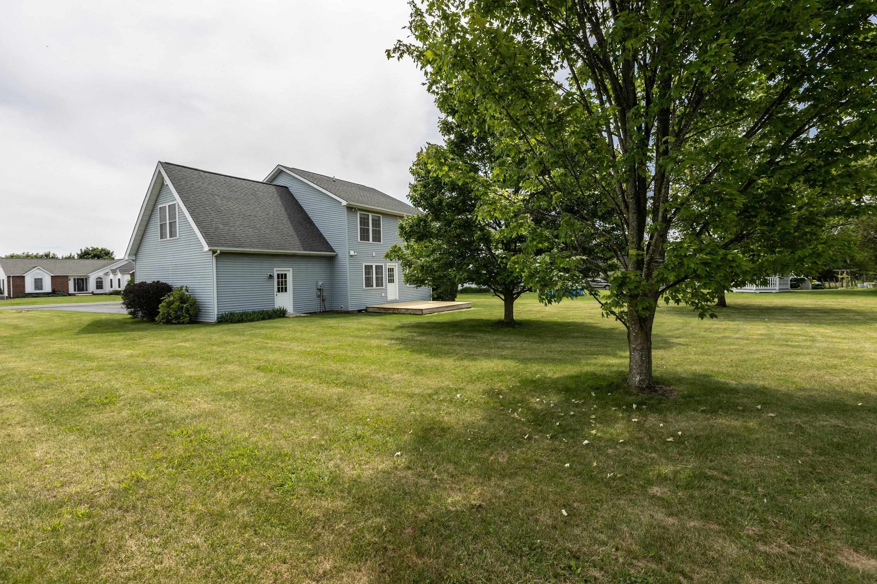 The back view of the home highlights the spacious, mostly level yard, extensive landscapting, mature trees, and much more! The back view of the home highlights the spacious, mostly level yard, extensive landscapting, mature trees, and much more!