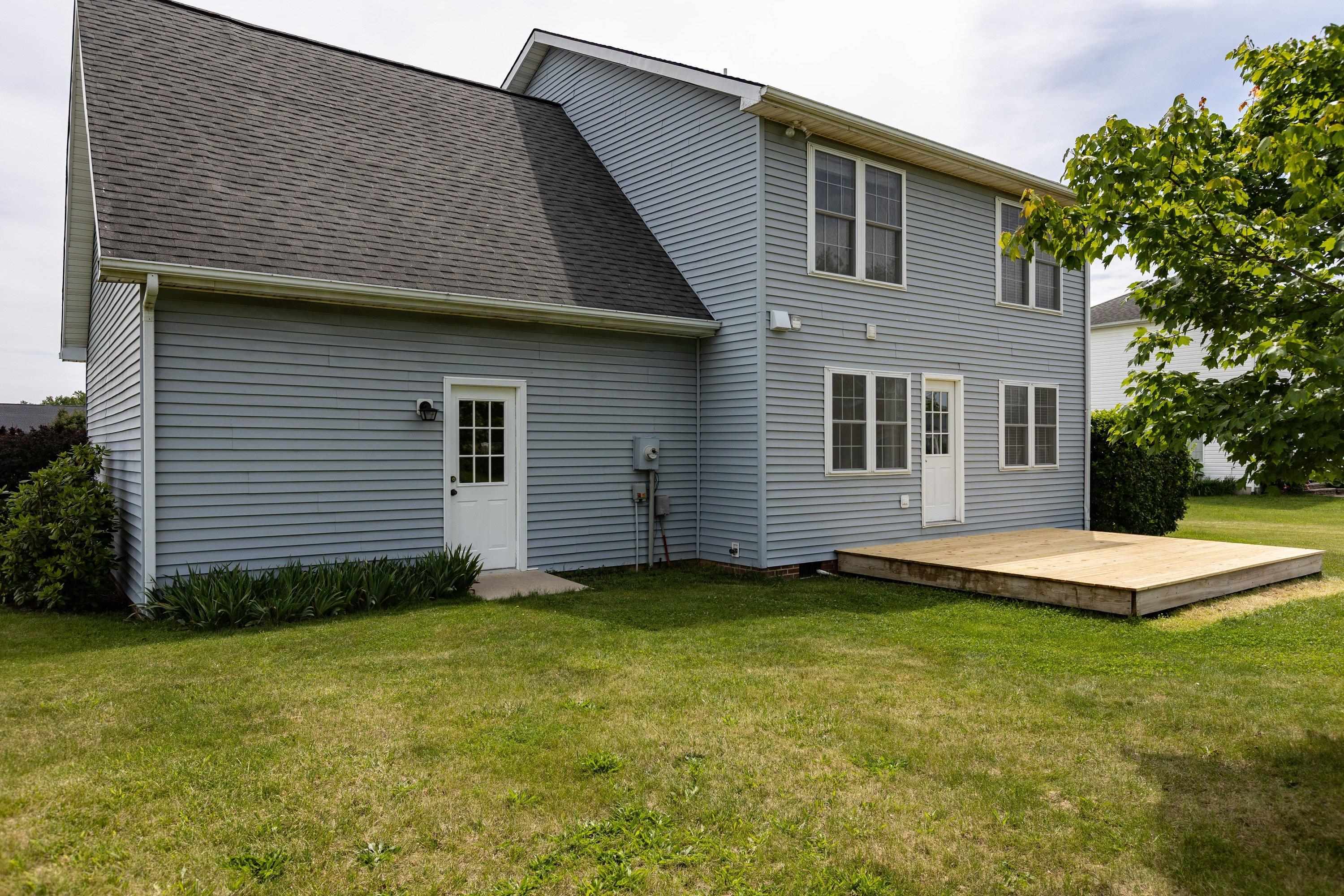 The back view of the home highlights the spacious, mostly level yard, extensive landscapting, mature trees, and much more! The back view of the home highlights the spacious, mostly level yard, extensive landscapting, mature trees, and much more!