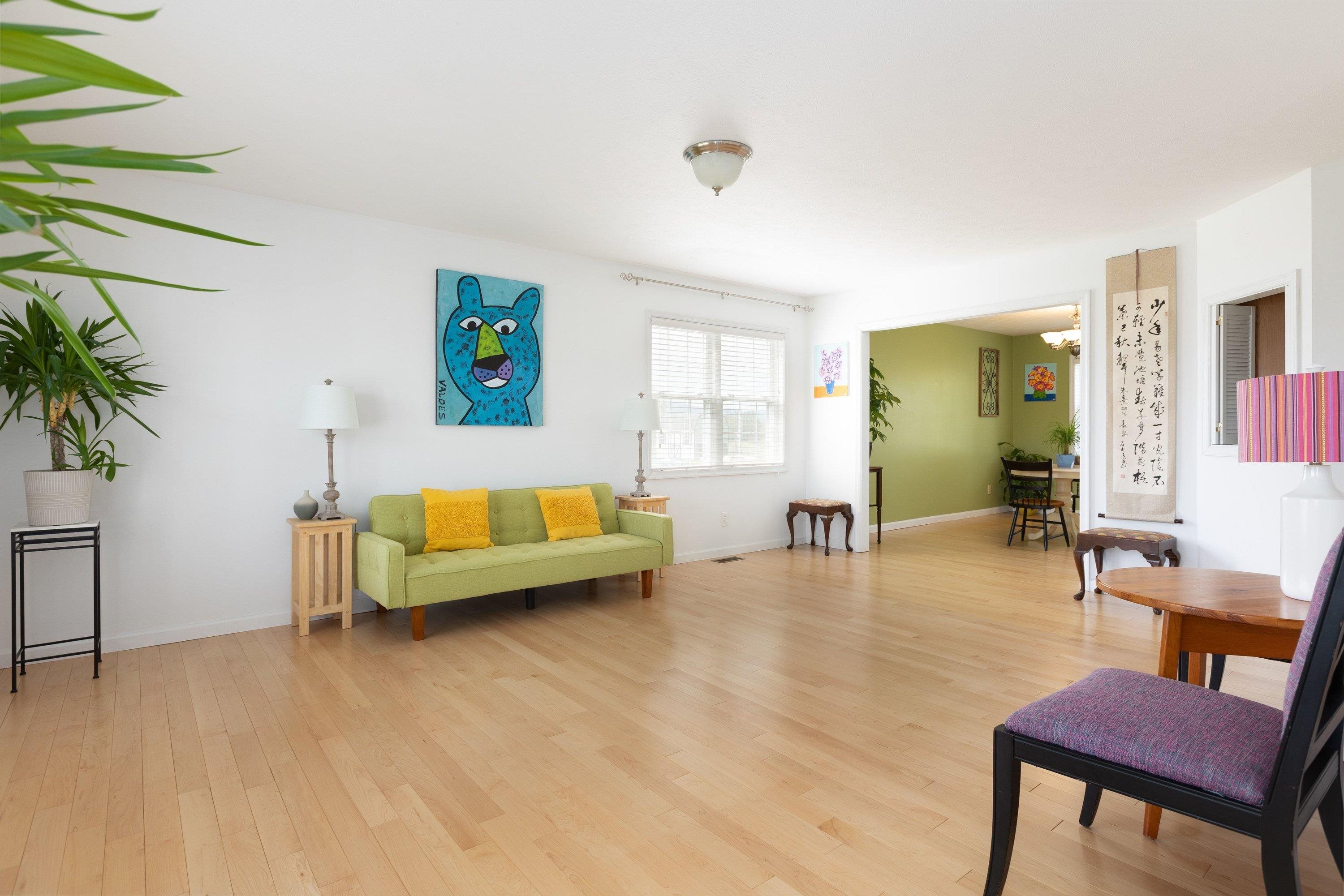 The living room space features hardwood flooring throughout, large windows, and a large space for gathering with family and friends. The living room space features hardwood flooring throughout, large windows, and a large space for gathering with family and friends.