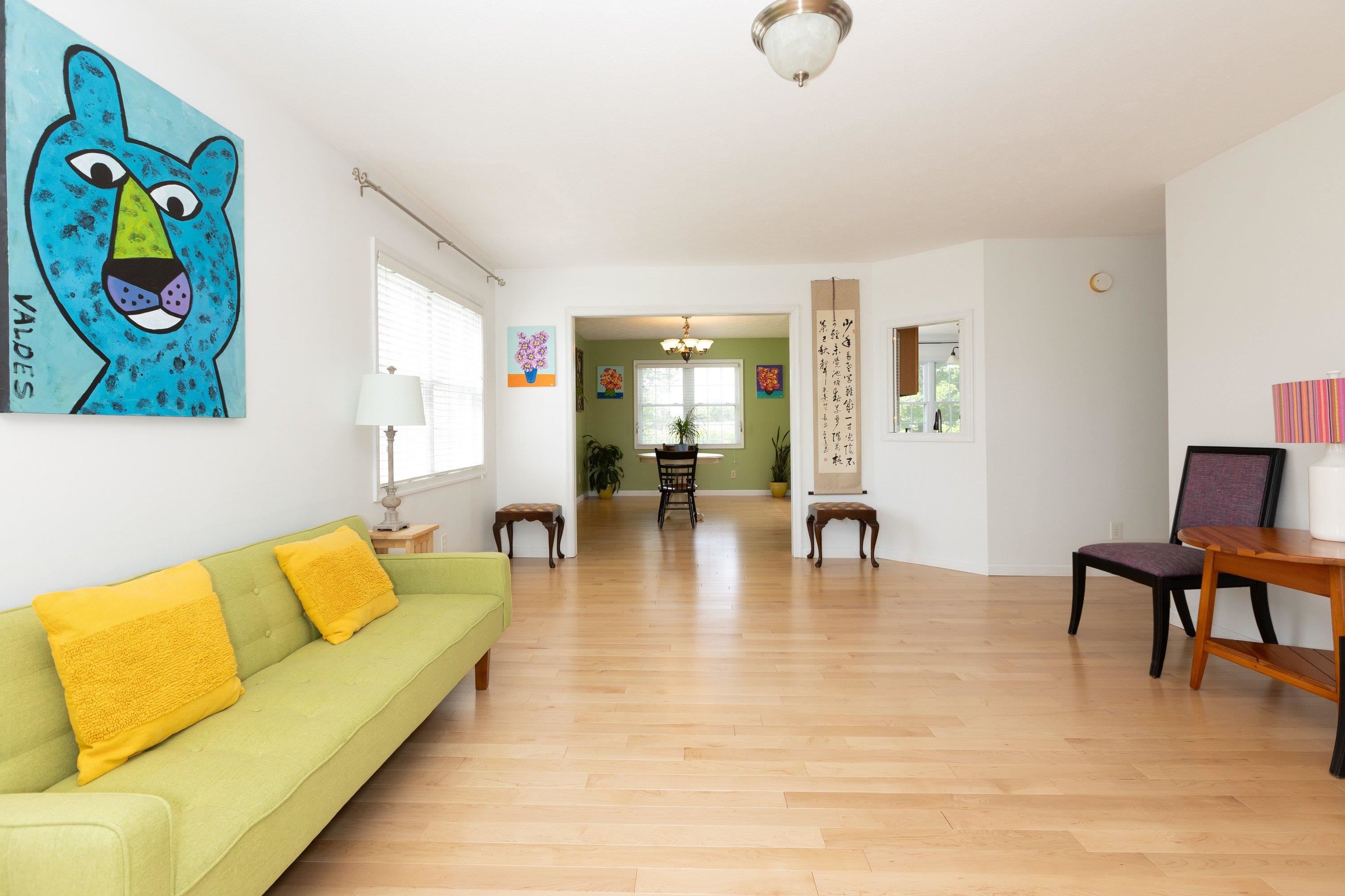 The living room space features hardwood flooring throughout, large windows, and a large space for gathering with family and friends. The living room space features hardwood flooring throughout, large windows, and a large space for gathering with family and friends.