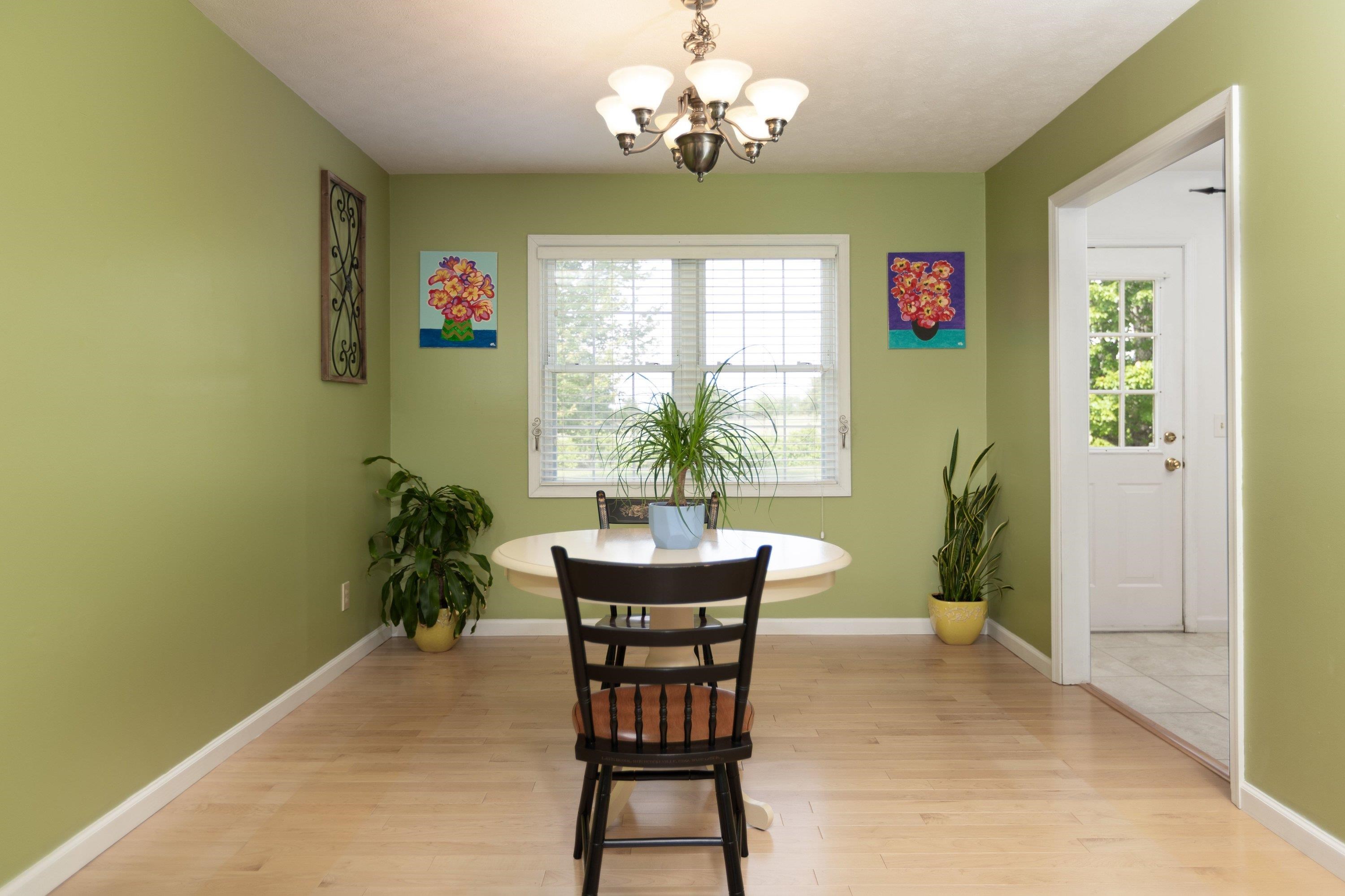 The dining room features hardwood flooring throughout, dining chandelier, large windows, and plenty of room for a table and chairs set. The dining room features hardwood flooring throughout, dining chandelier, large windows, and plenty of room for a table and chairs set.