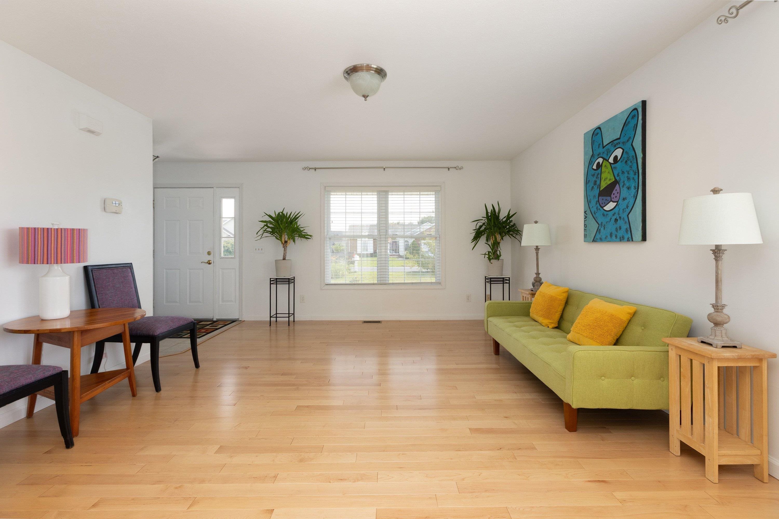 The living room space features hardwood flooring throughout, large windows, and a large space for gathering with family and friends. The living room space features hardwood flooring throughout, large windows, and a large space for gathering with family and friends.